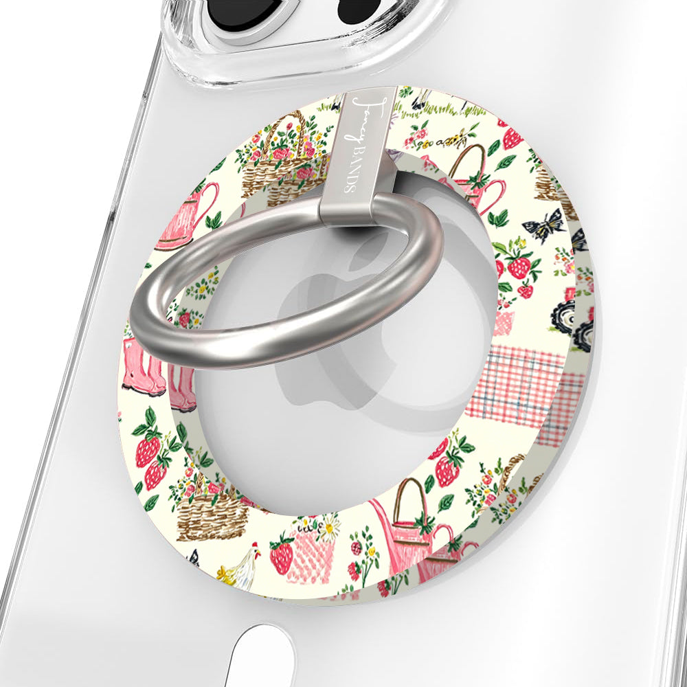 Farm Girl Cutie cottagecore MagSafe phone grip ring with pink watering cans, strawberries, rain boots, and gingham patterns on an off-white background compatible with iPhone and Samsung