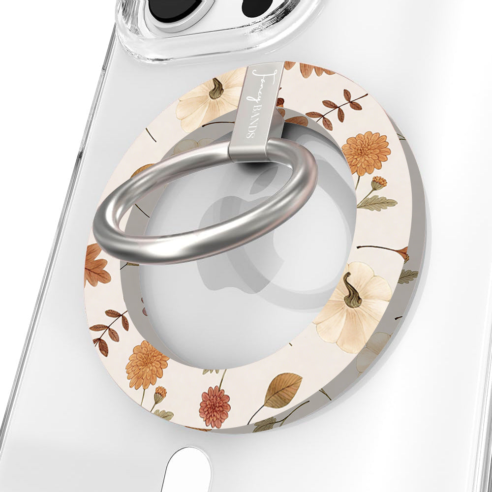Fall Floral Bliss Hold It Fancy MagSafe grip ring close-up on a clear iPhone case, showing the cream base with watercolor rust mums, cream pumpkins, golden oak leaves, and acorns around the silver rotating ring.