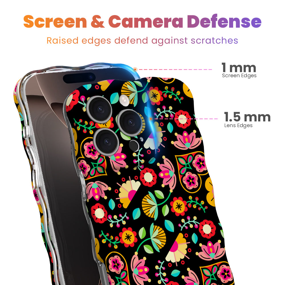 Trendy black wavy iPhone case featuring an intricate folk art botanical pattern of red flowers, magenta details, and yellow fan petals with a high-gloss finish.