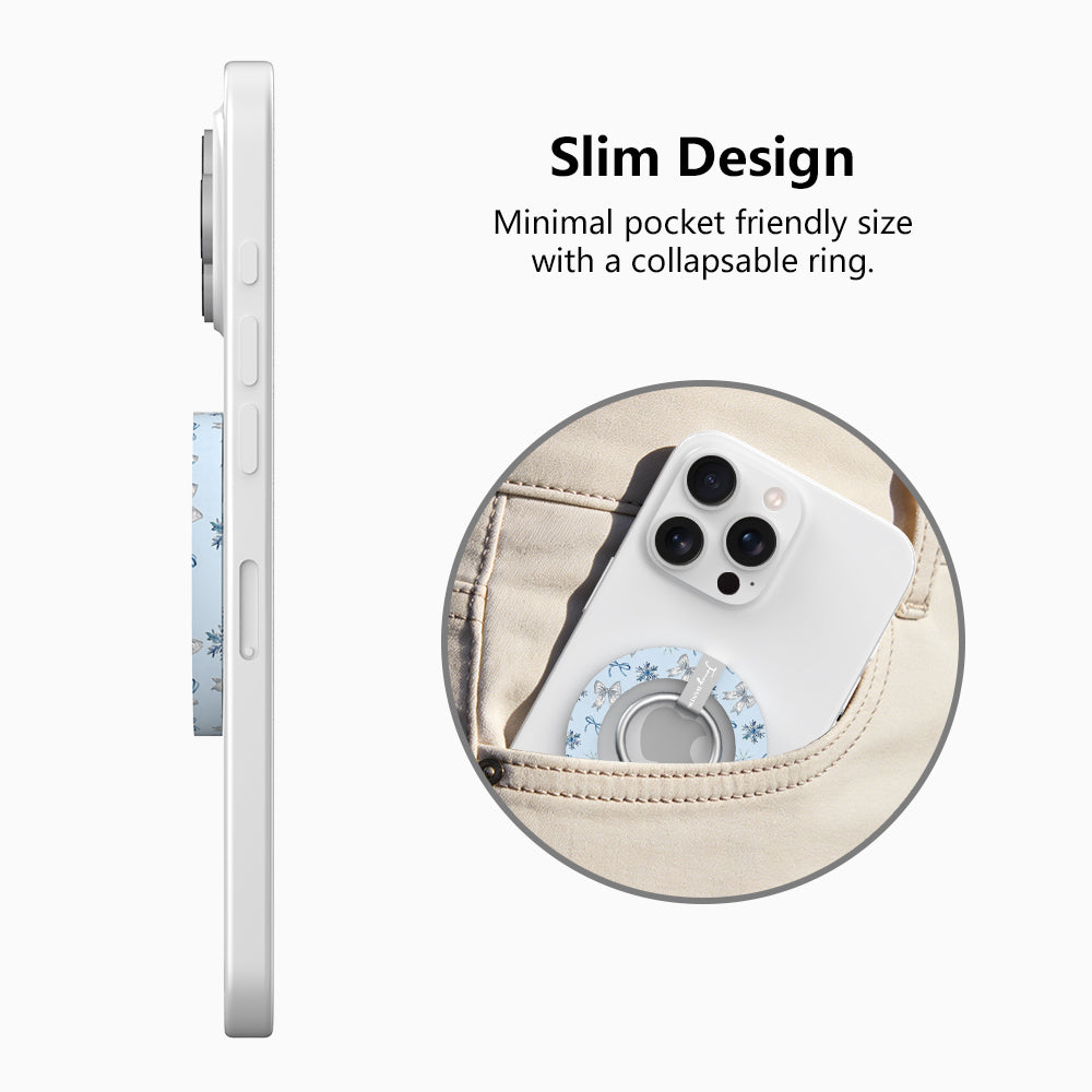 Side view of the slim Snow Pretty In Blue grip ring with collapsible ring, and a phone with the snowflake bow grip sliding into a jeans pocket