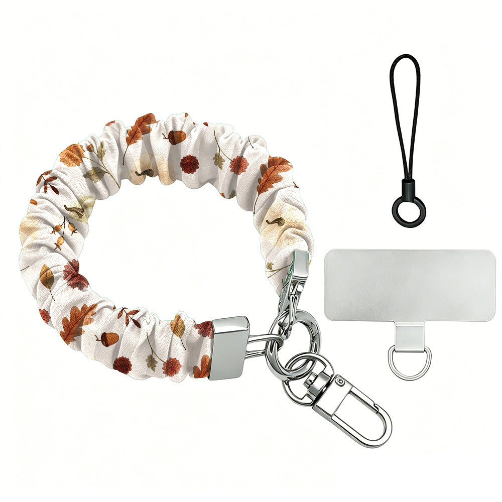 Fall Floral Bliss scrunchie phone wrist strap on a white background, showing the cream fabric with rust and olive autumn florals, silver lobster clasp, black loop cord, and clear attachment tab.