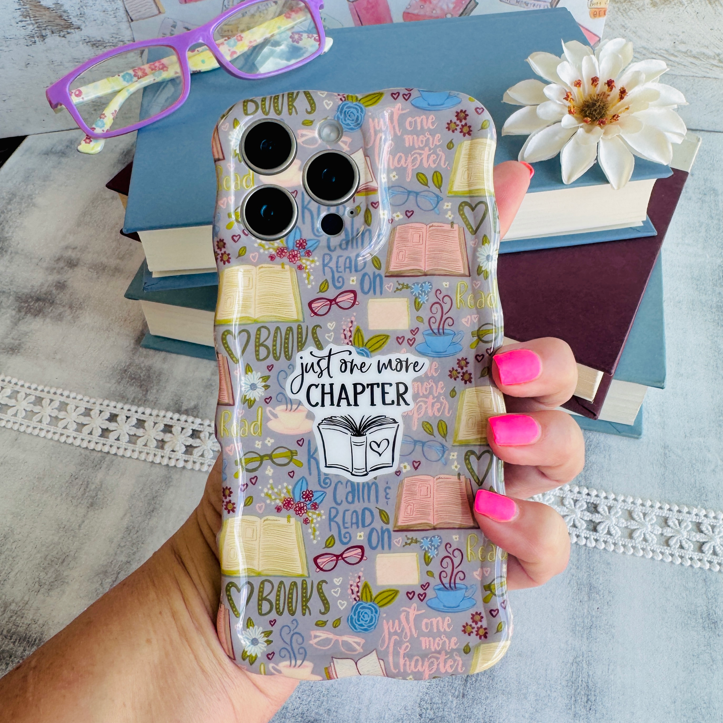 One More Chapter MagSafe iPhone case with books, reading glasses, and book quotes by Fancy Bands