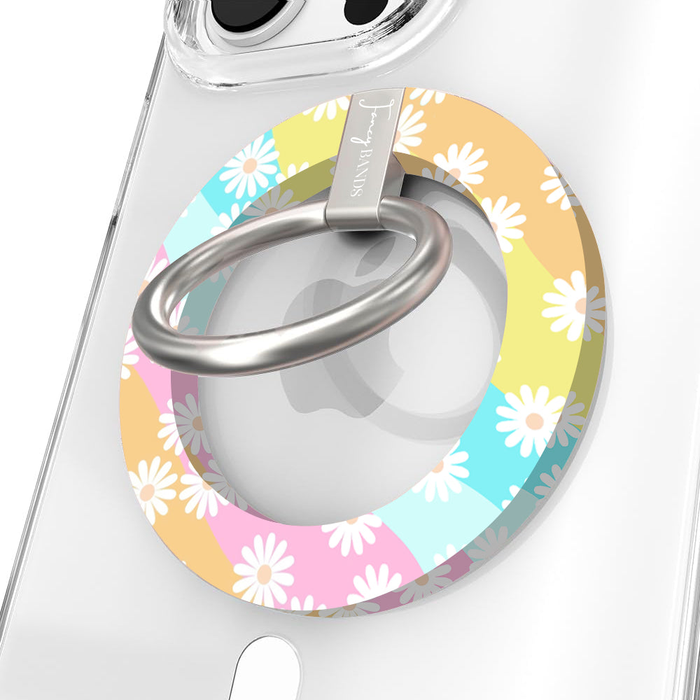 Daisy Dream MagSafe grip ring with pastel rainbow waves and white daisies on phone