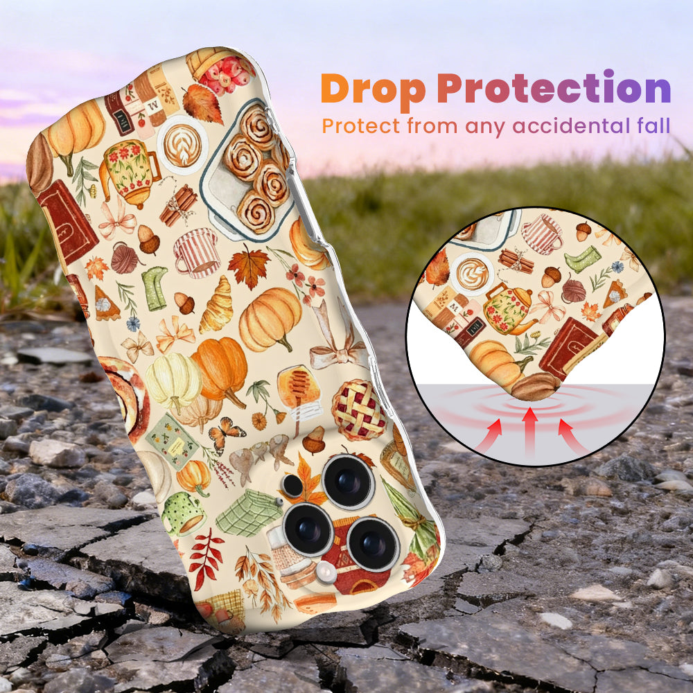 Drop protection diagram for the All The Fall Things Wavy Luxe iPhone case, showing the shock-absorbing raised edges that protect the cream watercolor fall print against accidental falls.