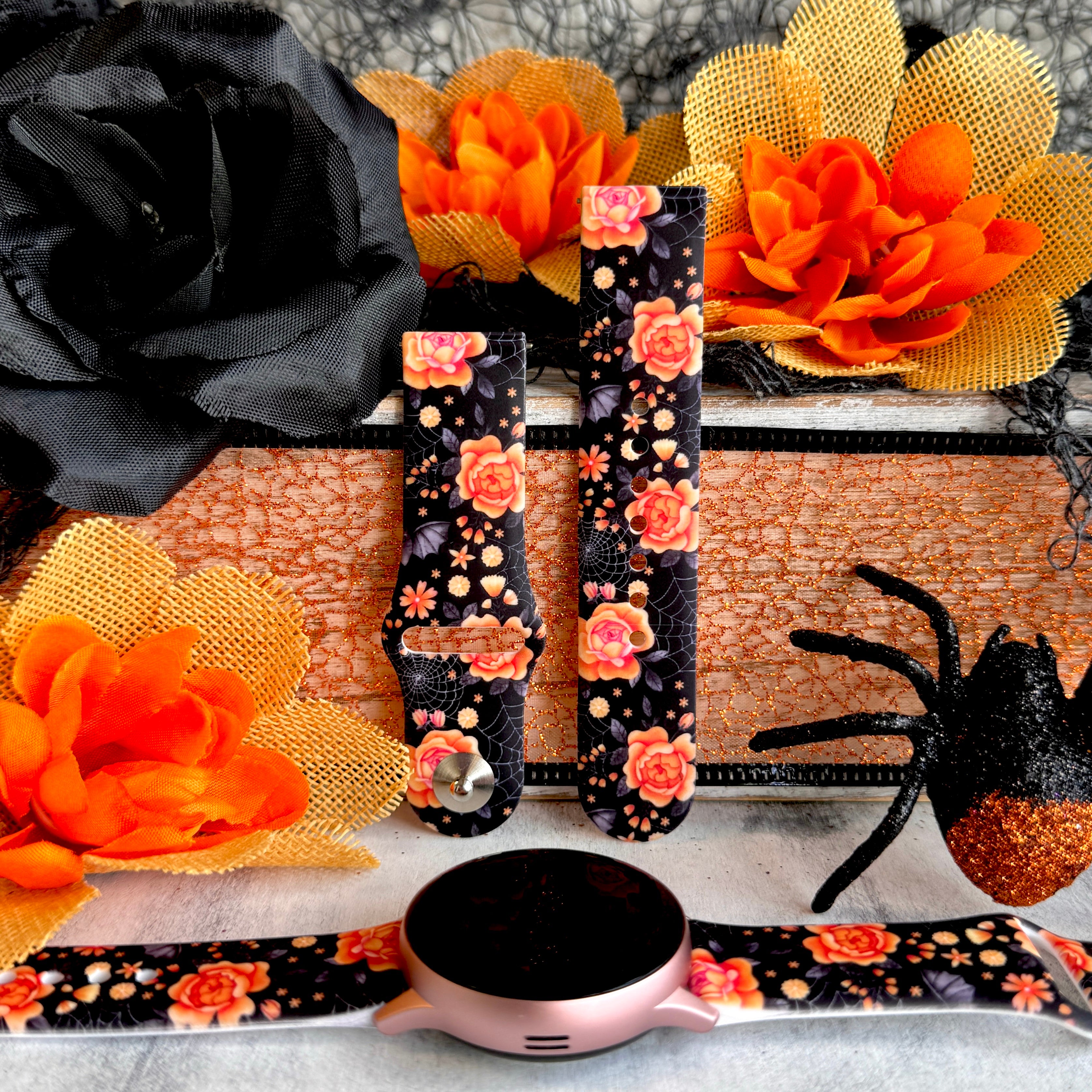 Haunted Blossoms silicone Samsung Galaxy Watch band hero shot in black with coral roses, shown with a rose gold Galaxy Watch.