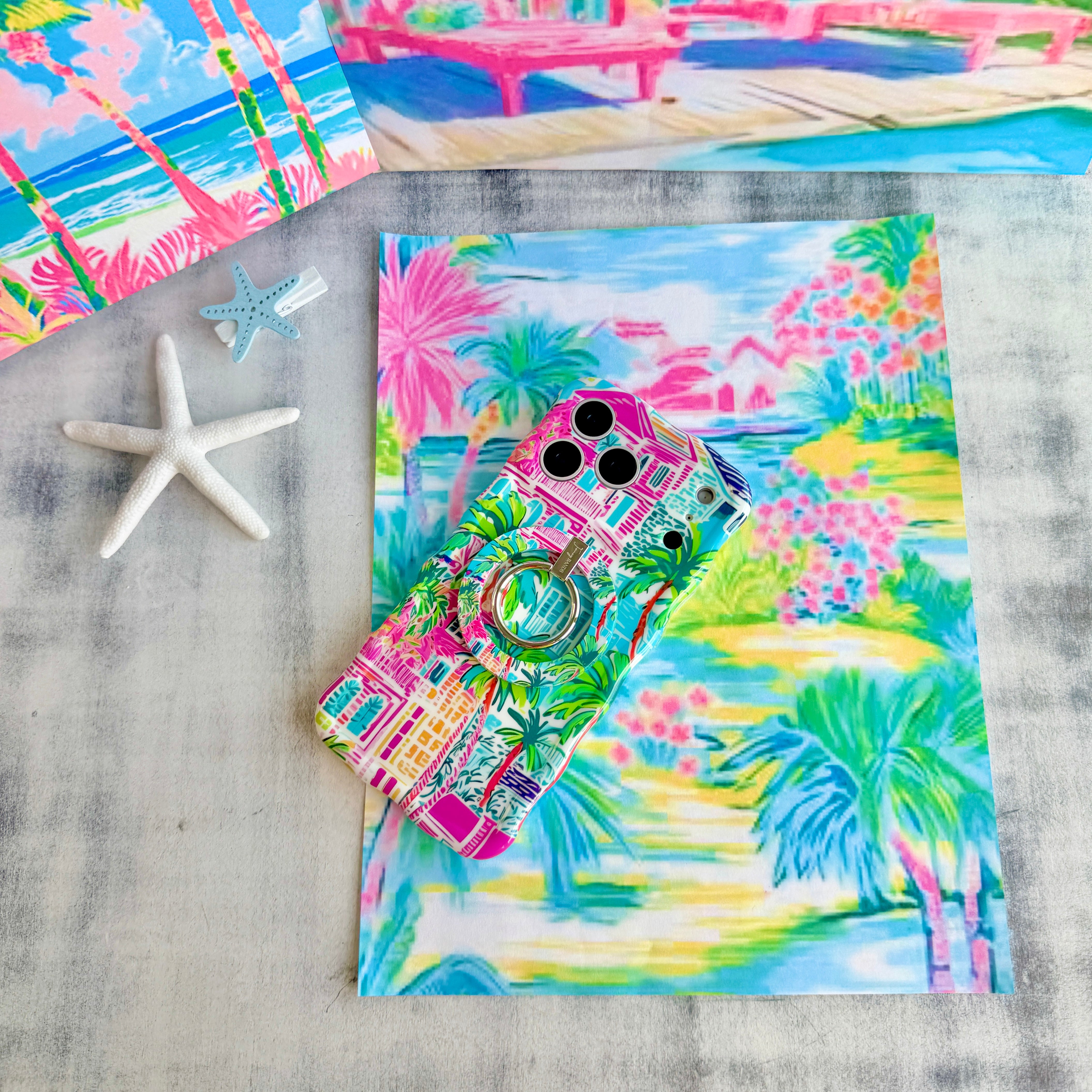 Trendy wavy iPhone case featuring a vibrant tropical resort scene with pink villas and green palm trees with a high-gloss finish.