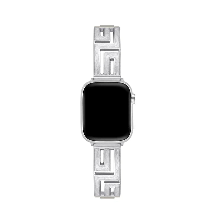 Axiom Link stainless steel Apple Watch band with Greek key cut-out pattern in brushed silver finish on a woman's wrist