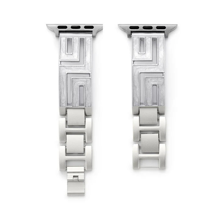 Axiom Link stainless steel Apple Watch band with Greek key cut-out pattern in brushed silver finish on a woman's wrist