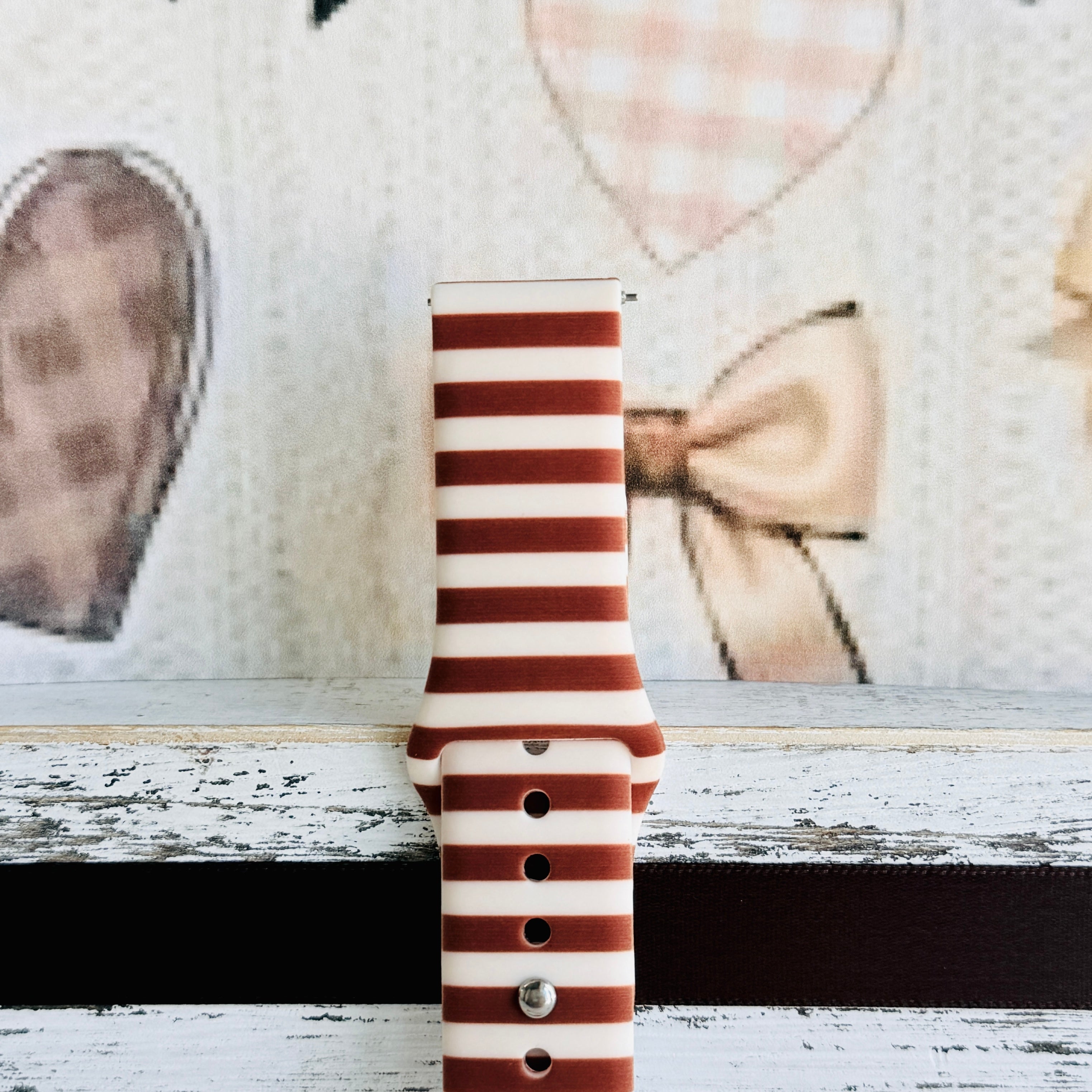 Close-up of the Sweet Espresso Stripes Samsung Galaxy Watch band showing the smooth silicone finish and the even spacing of the brown and cream stripes.