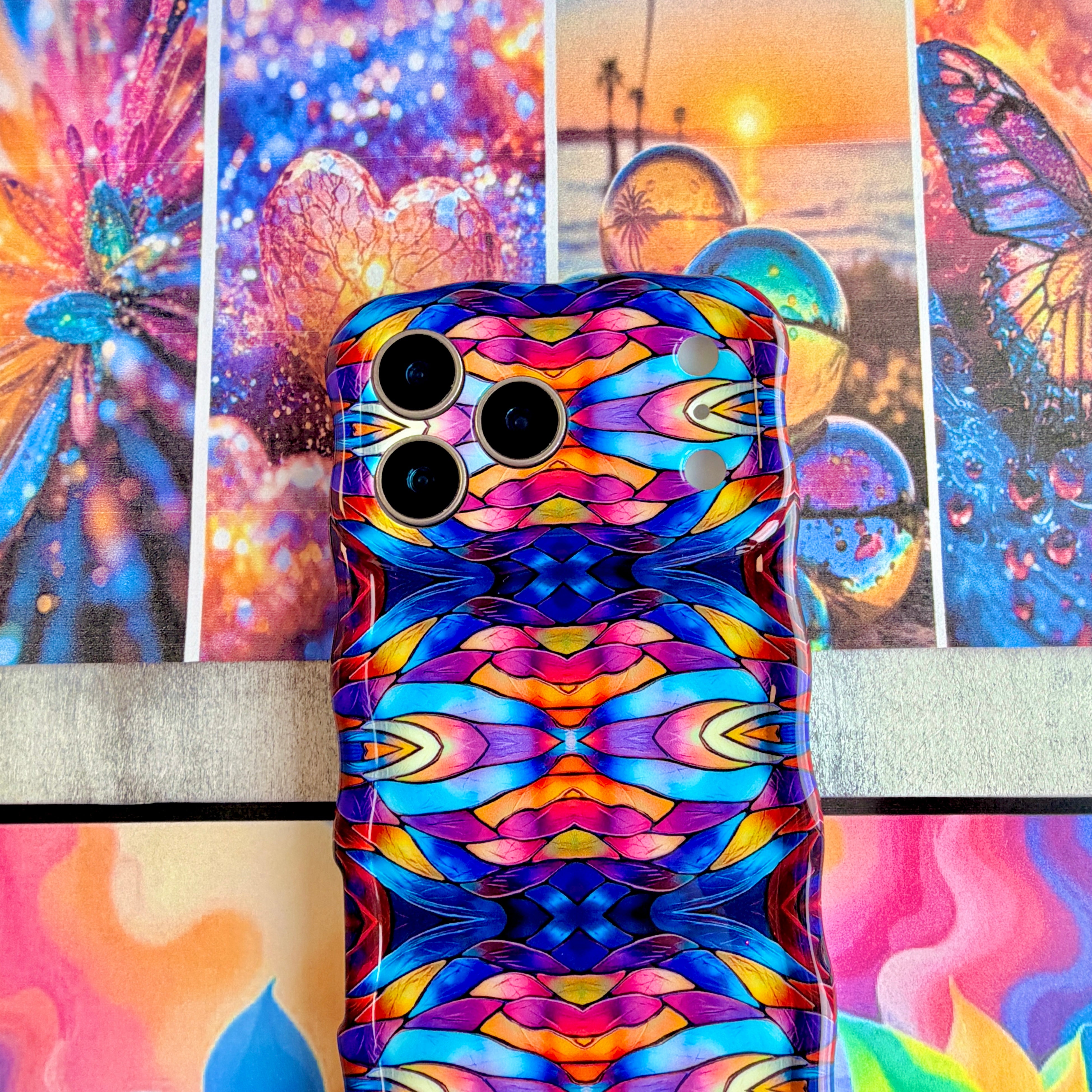 Vibrant wavy iPhone case featuring a symmetrical stained glass pattern in blue, purple, and orange.