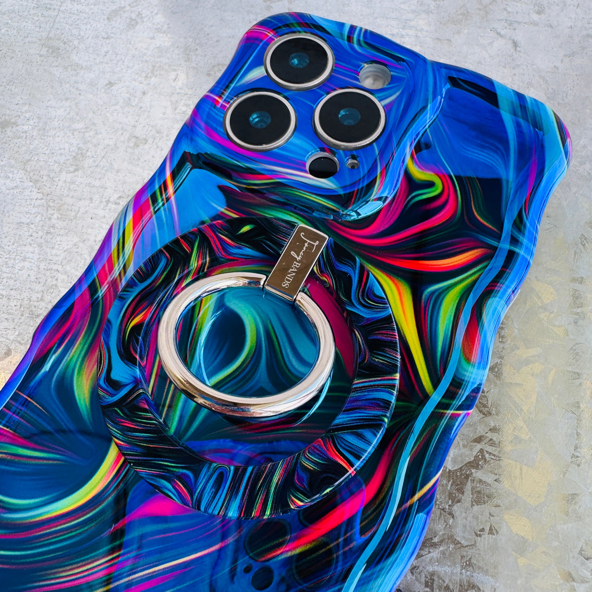 Neon Taffy Hold It Fancy MagSafe grip ring attached to the matching neon swirl iPhone case
