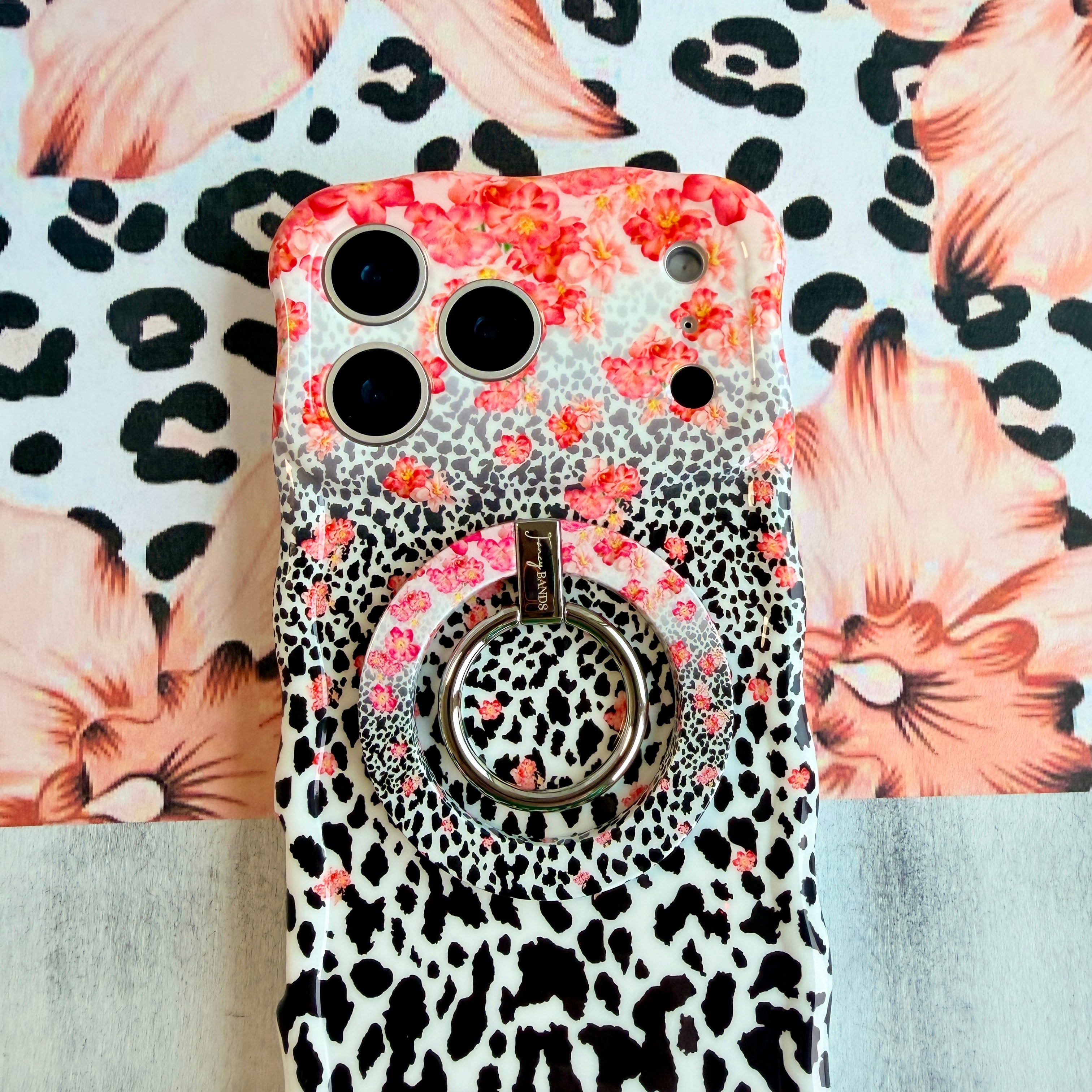 Flower-fetti Leopard pattern MagSafe phone grip ring with pink and orange flowers over black and white leopard spots compatible with iPhone and Samsung