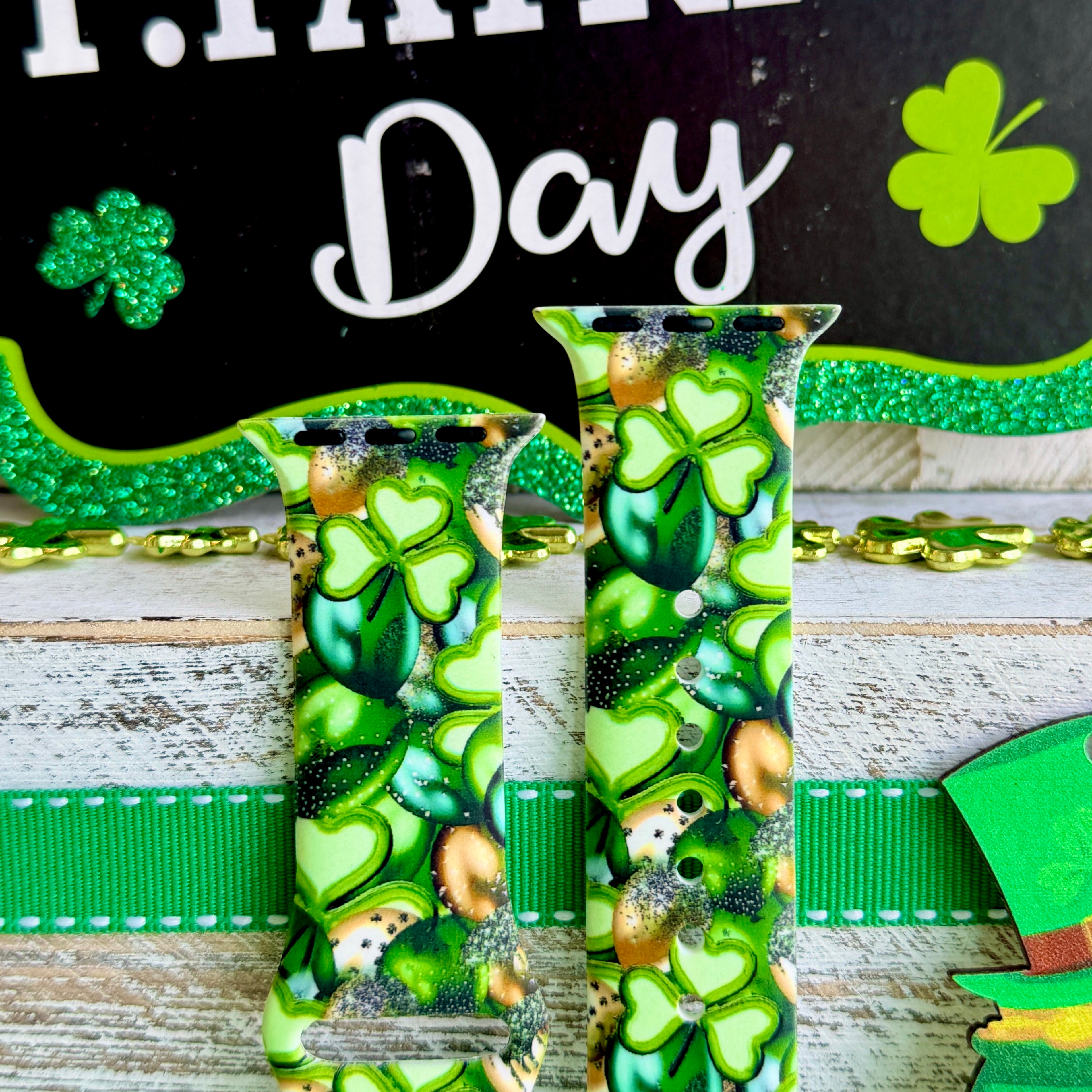 St. Patrick's Day Apple Watch band with green shamrocks, gold coins, and leprechaun hats on festive display