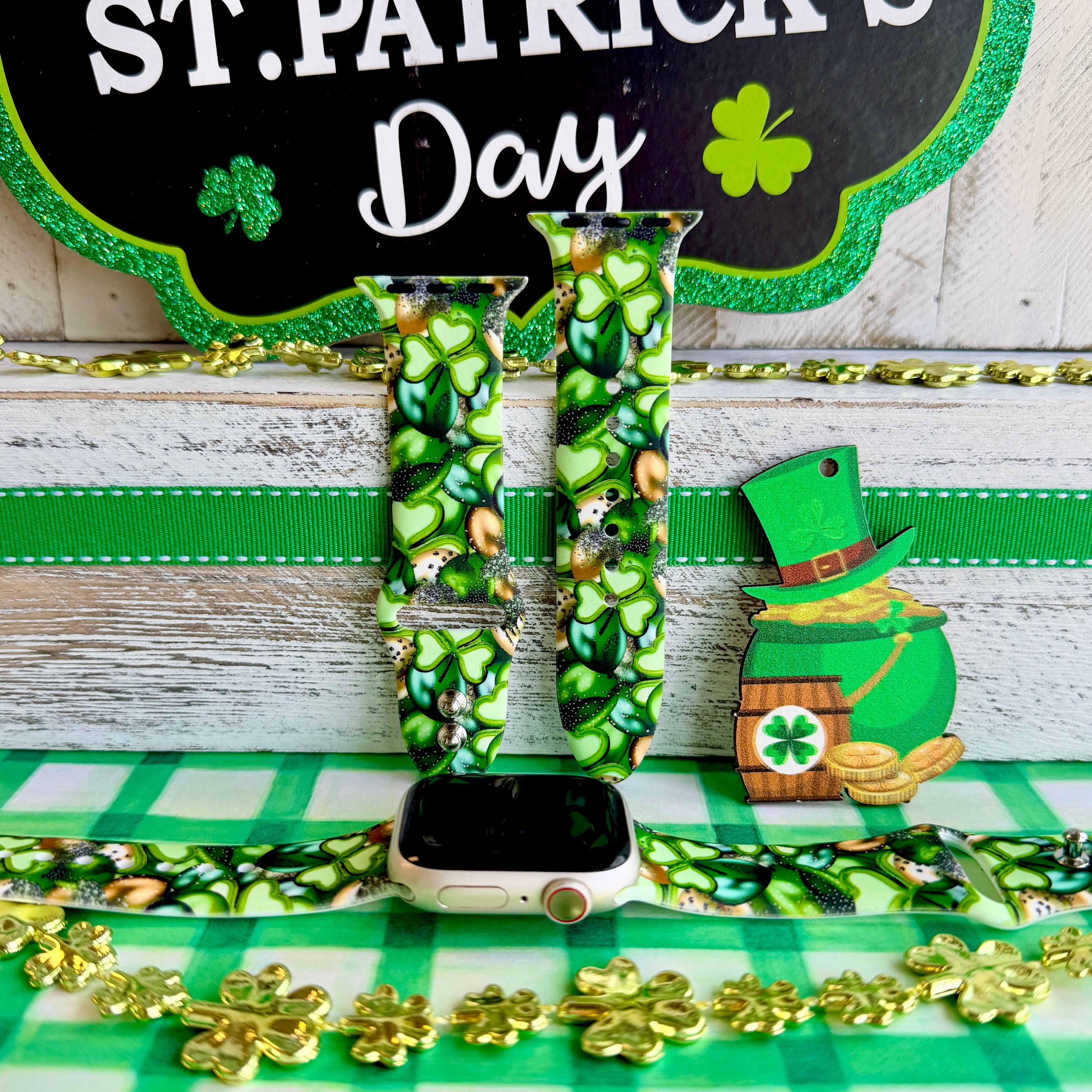 St. Patrick's Day Apple Watch band with green shamrocks, gold coins, and leprechaun hats on festive display