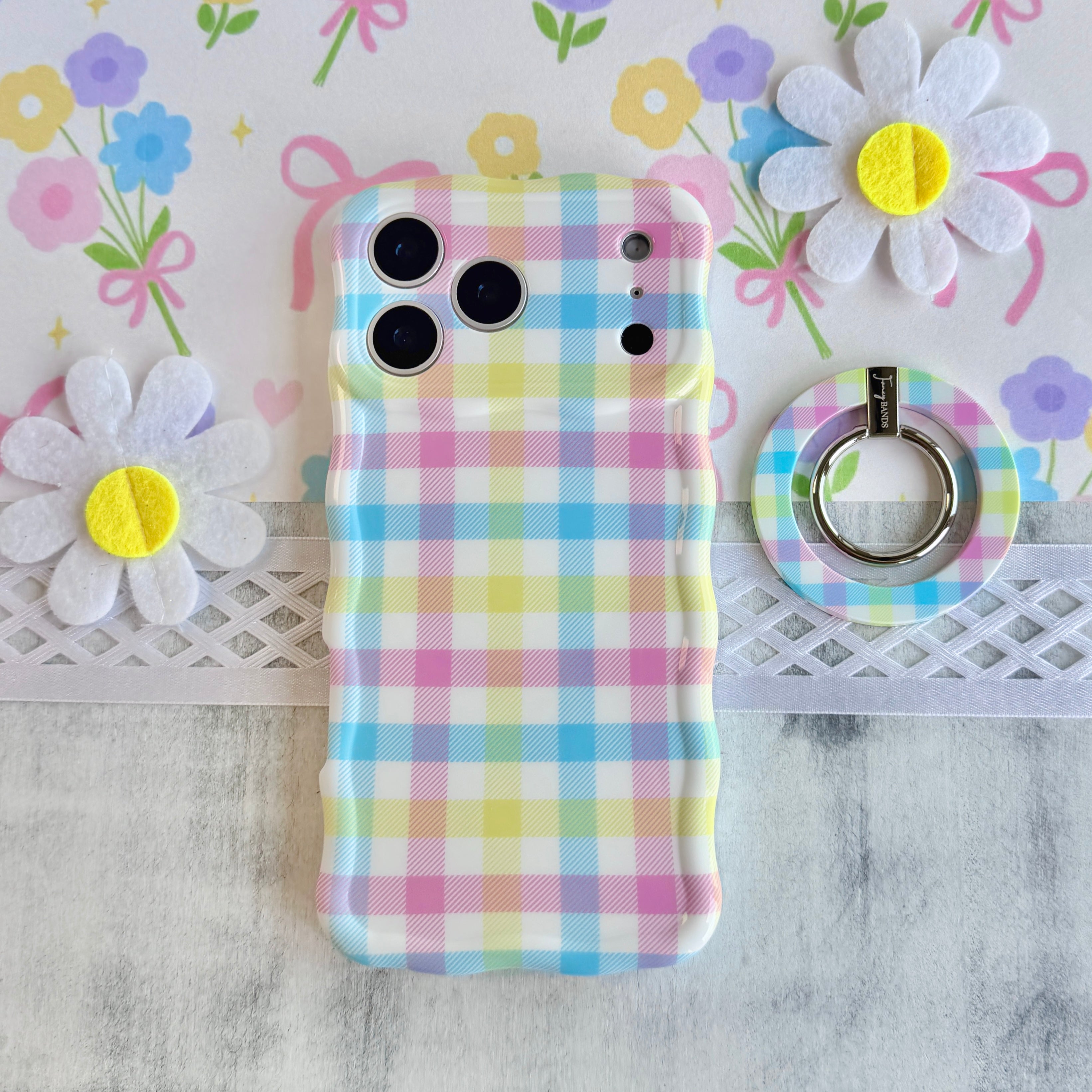 Pastel gingham phone ring grip used as kickstand for hands-free viewing