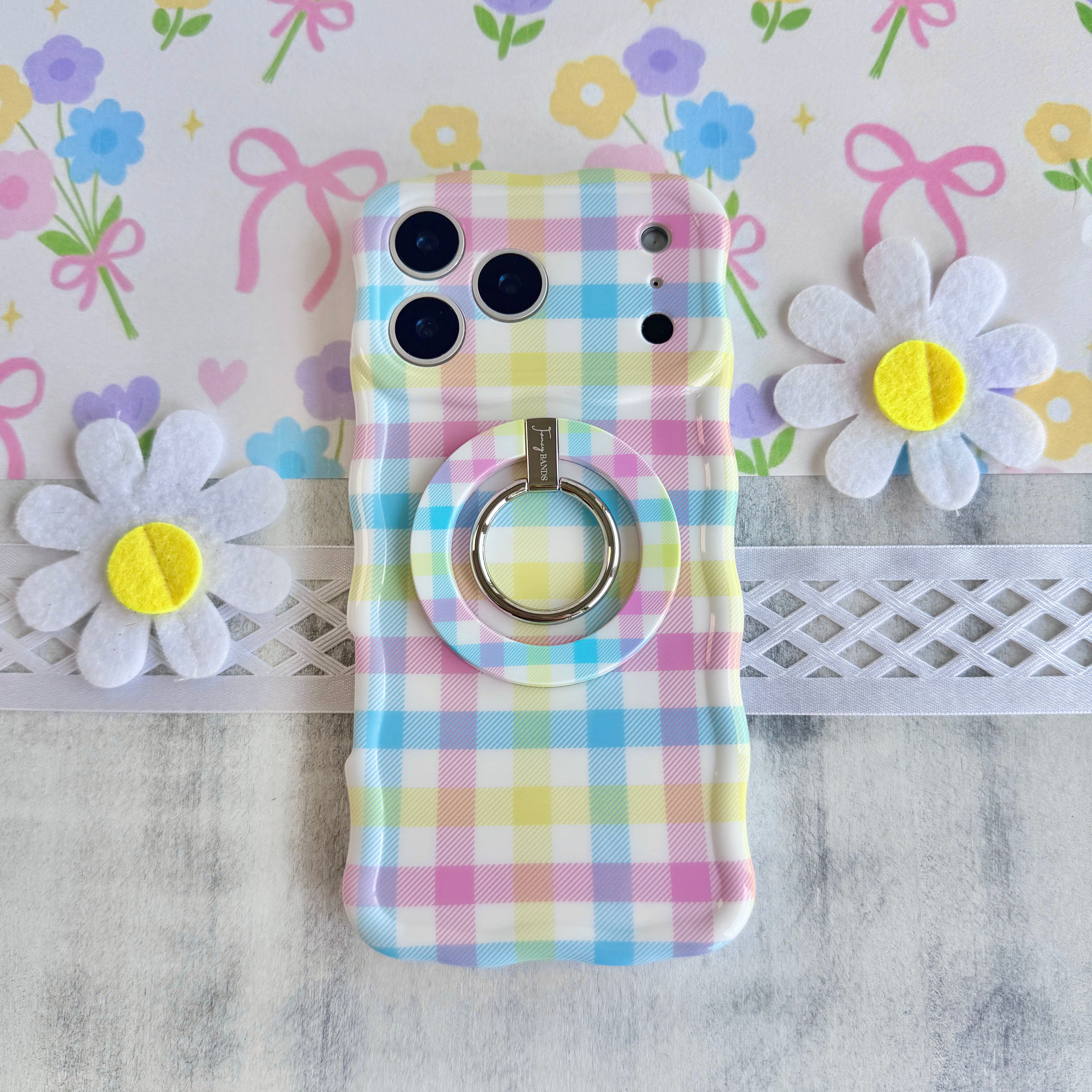Pastel gingham phone ring grip used as kickstand for hands-free viewing