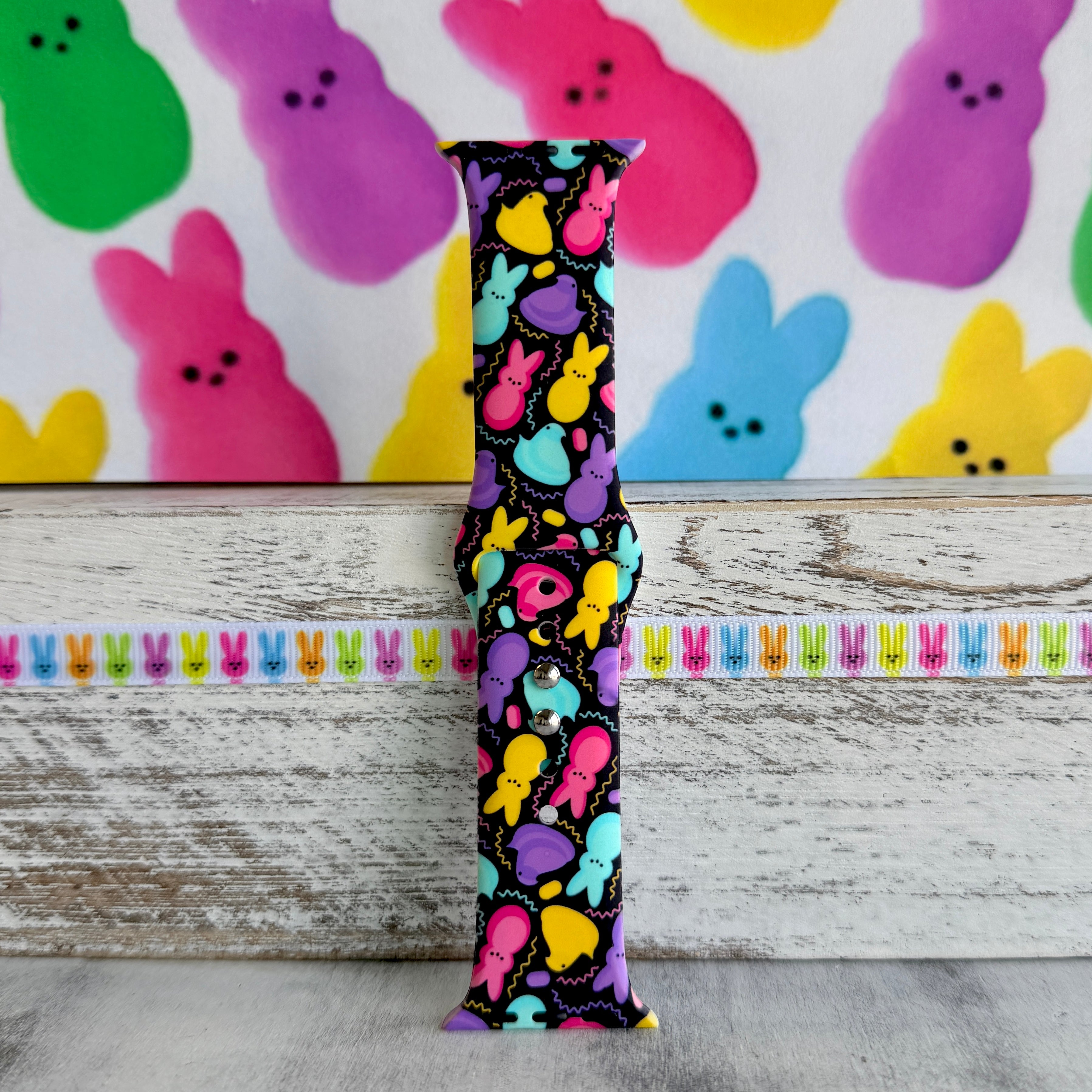 Neon Bunny Bash Apple Watch band with colorful peeps bunnies in pink, purple, yellow, and turquoise on black background