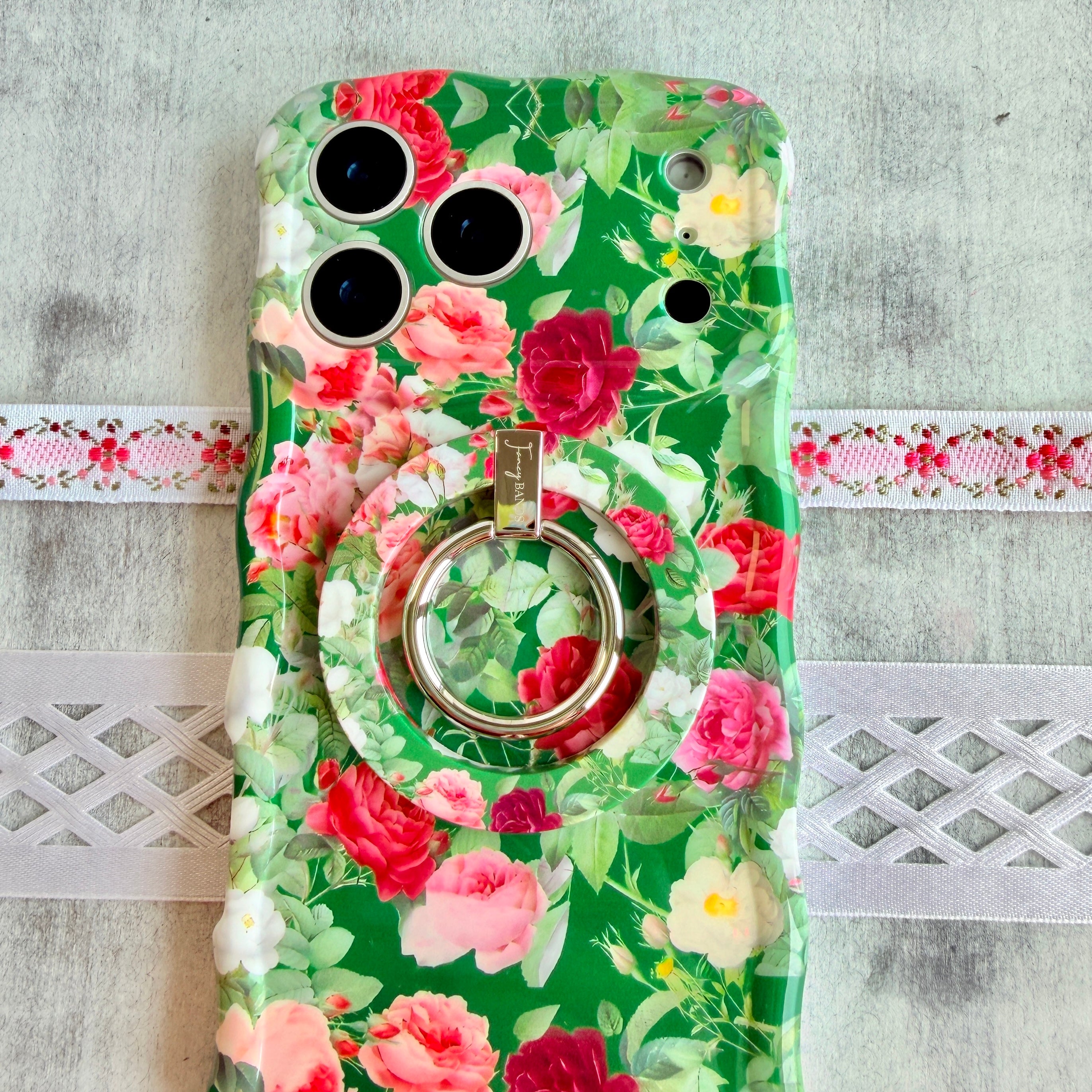 Garden Party pattern MagSafe phone grip ring with pink and white roses on a deep forest green background compatible with iPhone and Samsung