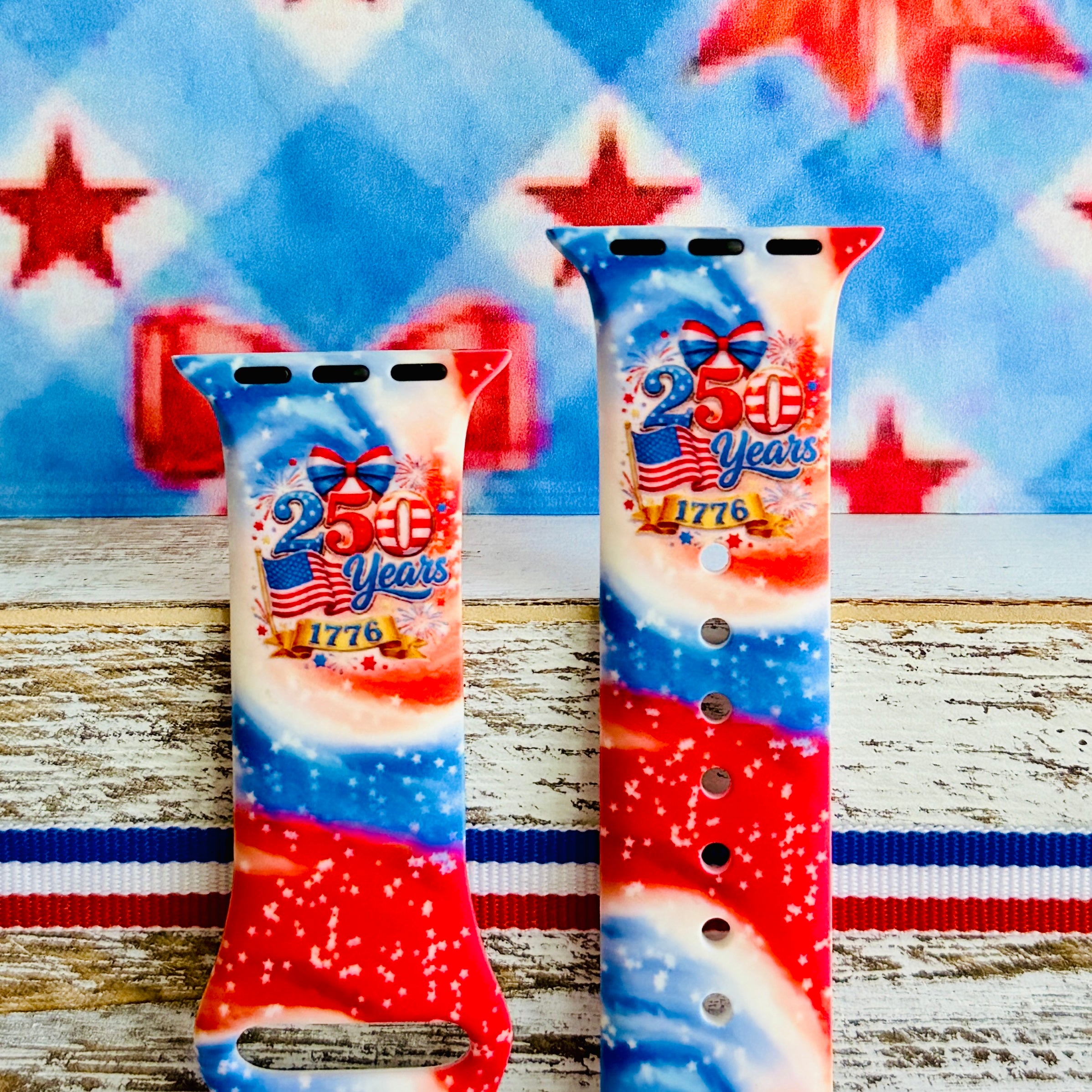 Sweet Freedom 250 silicone Apple Watch band celebrating America's 250th anniversary with "250 Years 1776" emblem, American flag, fireworks, red bow, and red, white, and blue tie-dye swirl with star sparkle, shown displayed and worn on Apple Watch against a patriotic 4th of July backdrop.