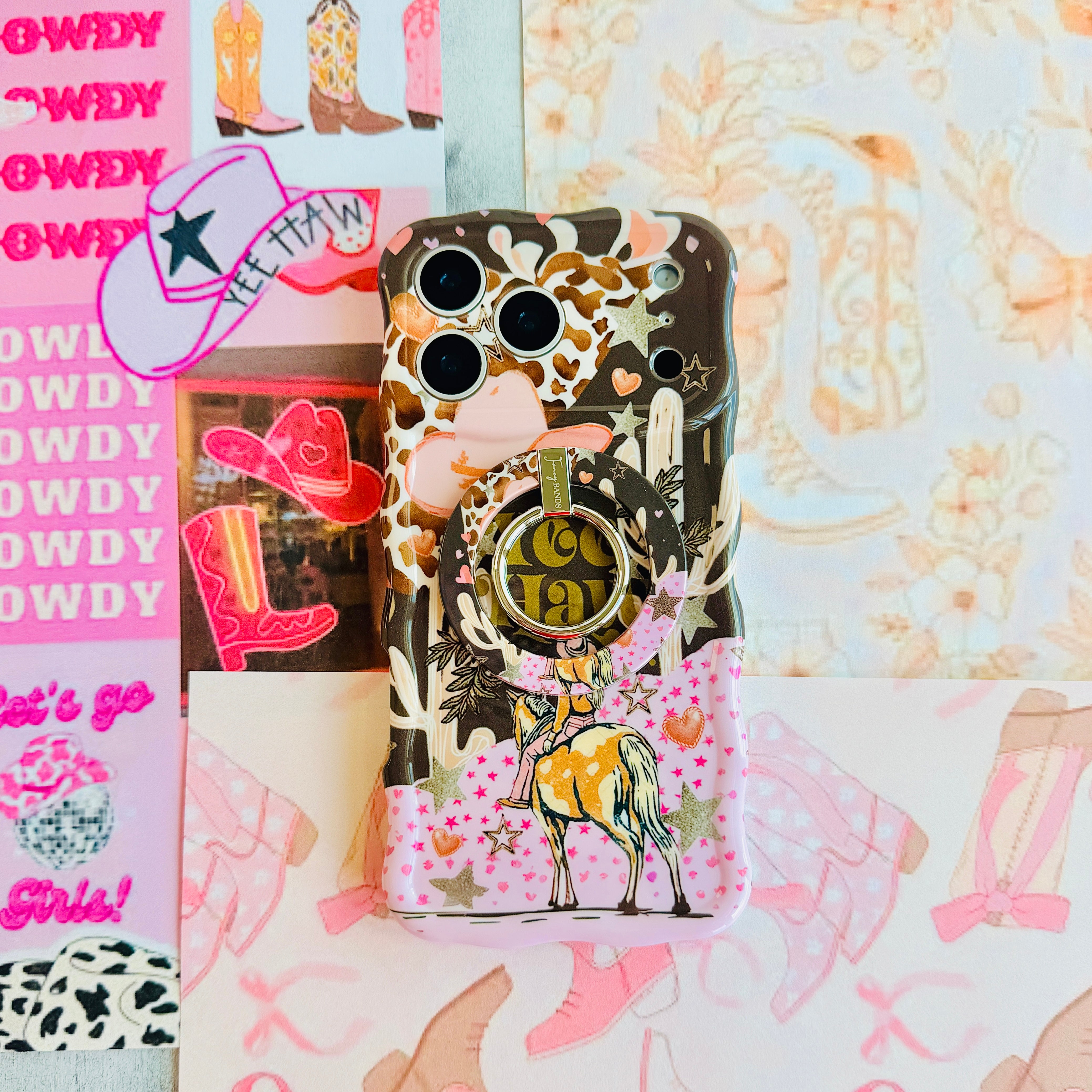 Yee Haw Honey retro Western MagSafe phone grip ring with a cowgirl on a horse, pink cowboy hat, desert cacti, glittery stars, and animal print on a brown and pink background compatible with iPhone and Samsung