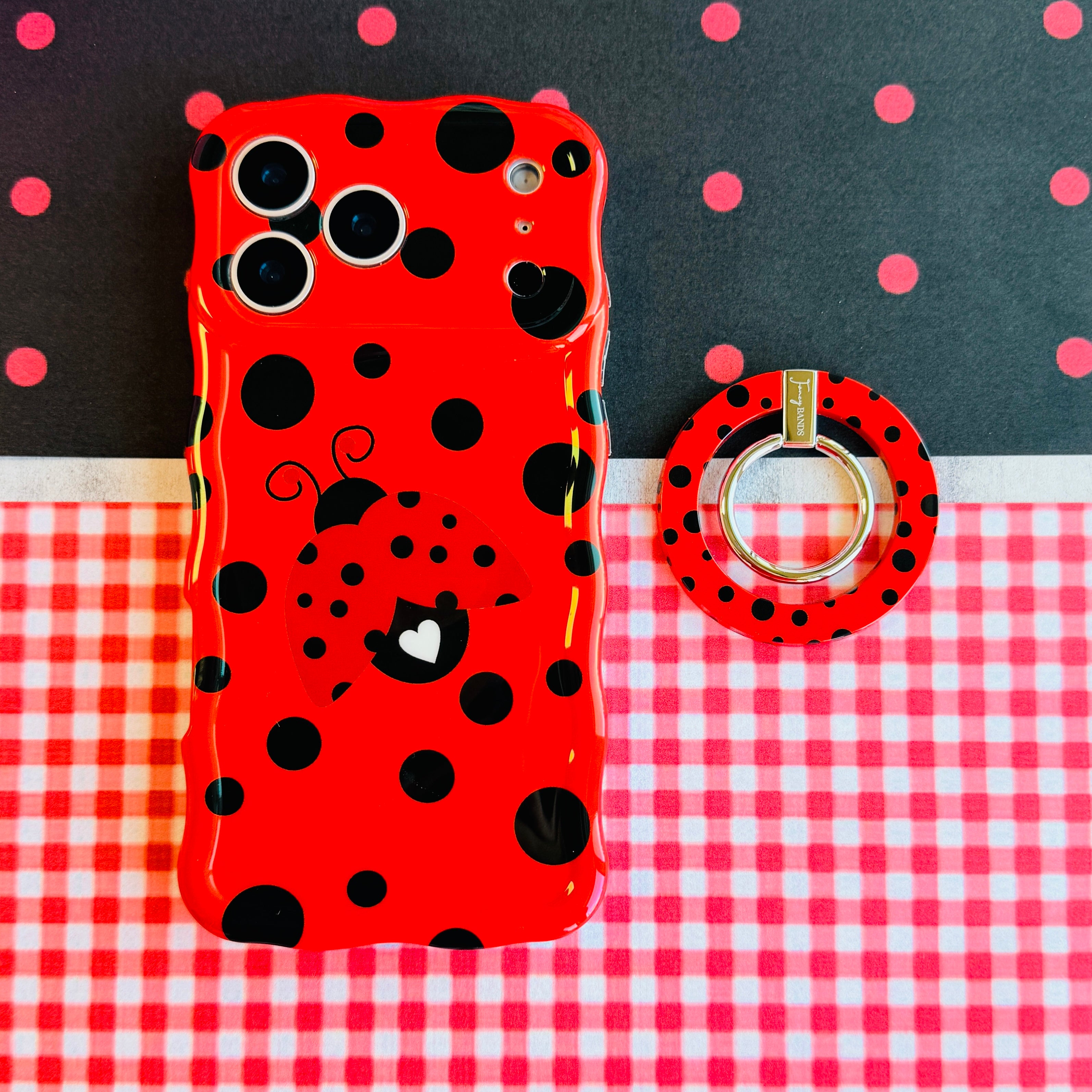 Ladybug pattern MagSafe phone grip ring with black polka dots on a vibrant red background compatible with iPhone and Samsung