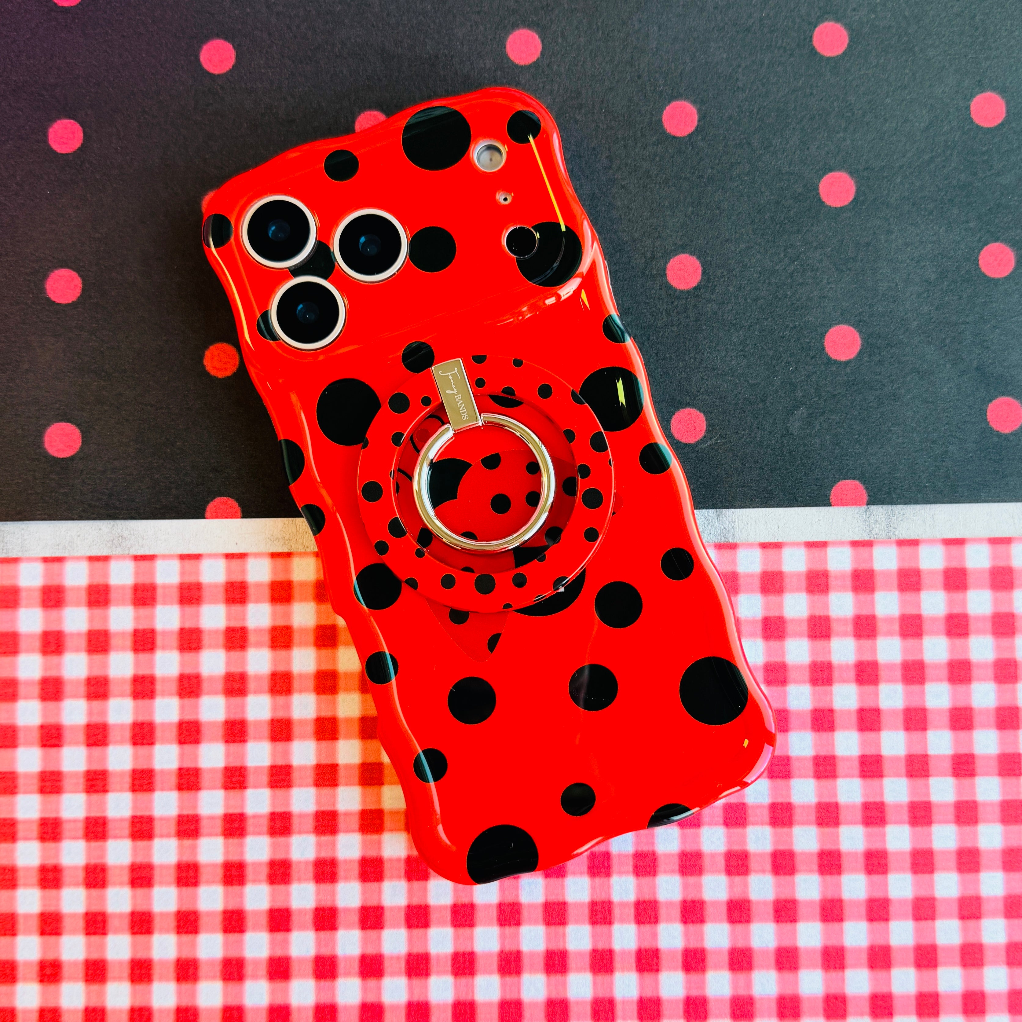 Ladybug pattern MagSafe phone grip ring with black polka dots on a vibrant red background compatible with iPhone and Samsung