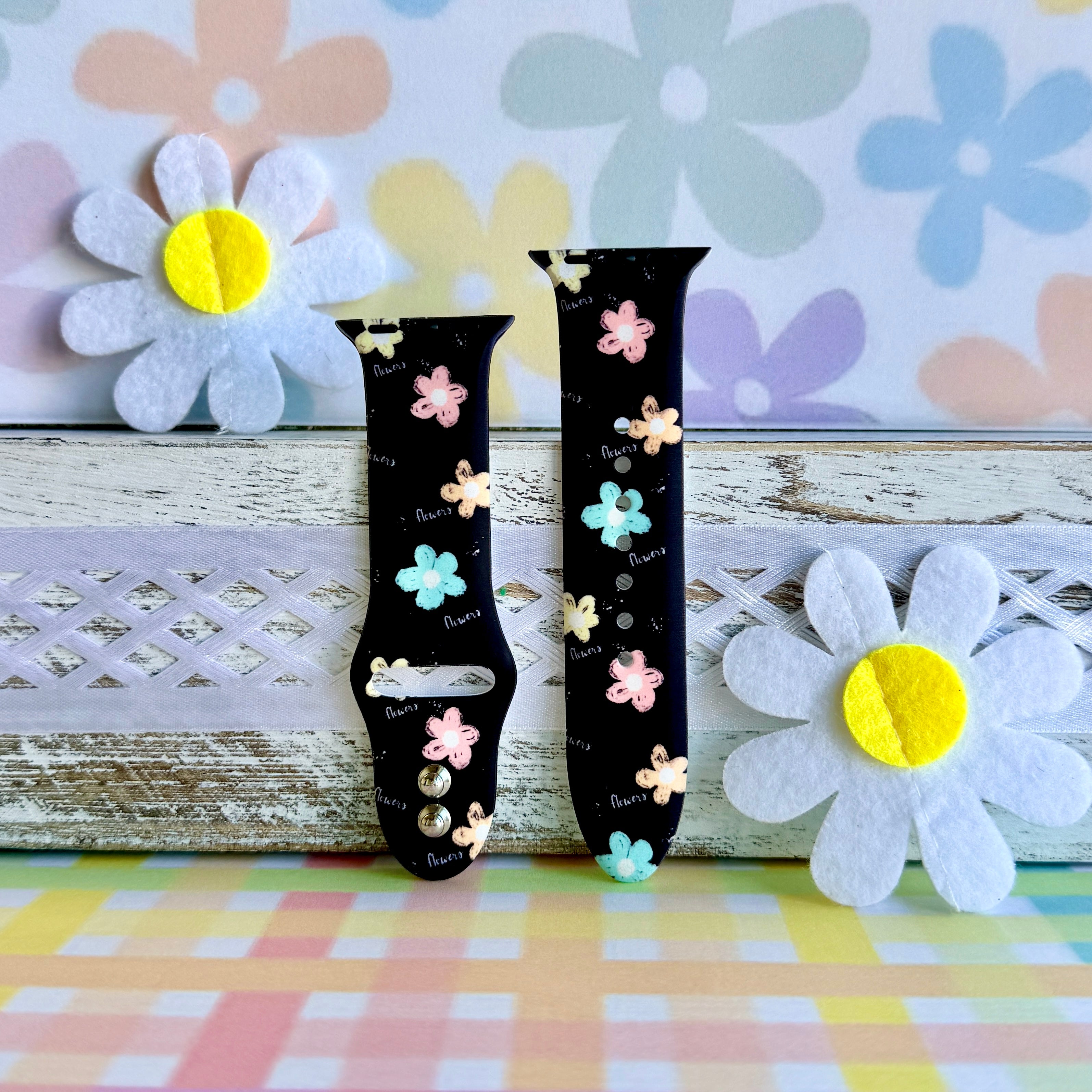 Flower Pop Apple Watch band with pastel flowers in pink, yellow, turquoise, and peach on black background with daisy decorations