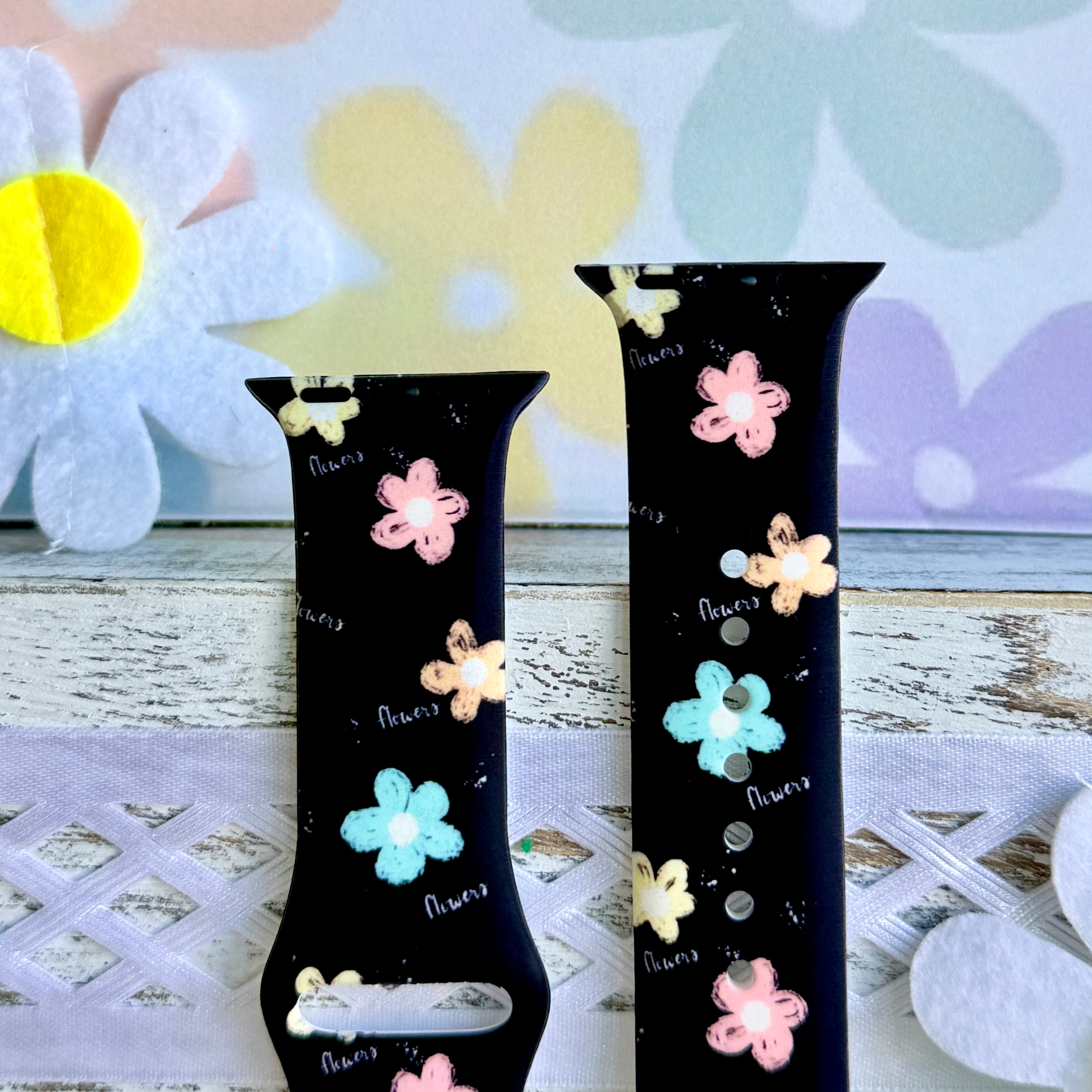 Flower Pop Apple Watch band with pastel flowers in pink, yellow, turquoise, and peach on black background with daisy decorations