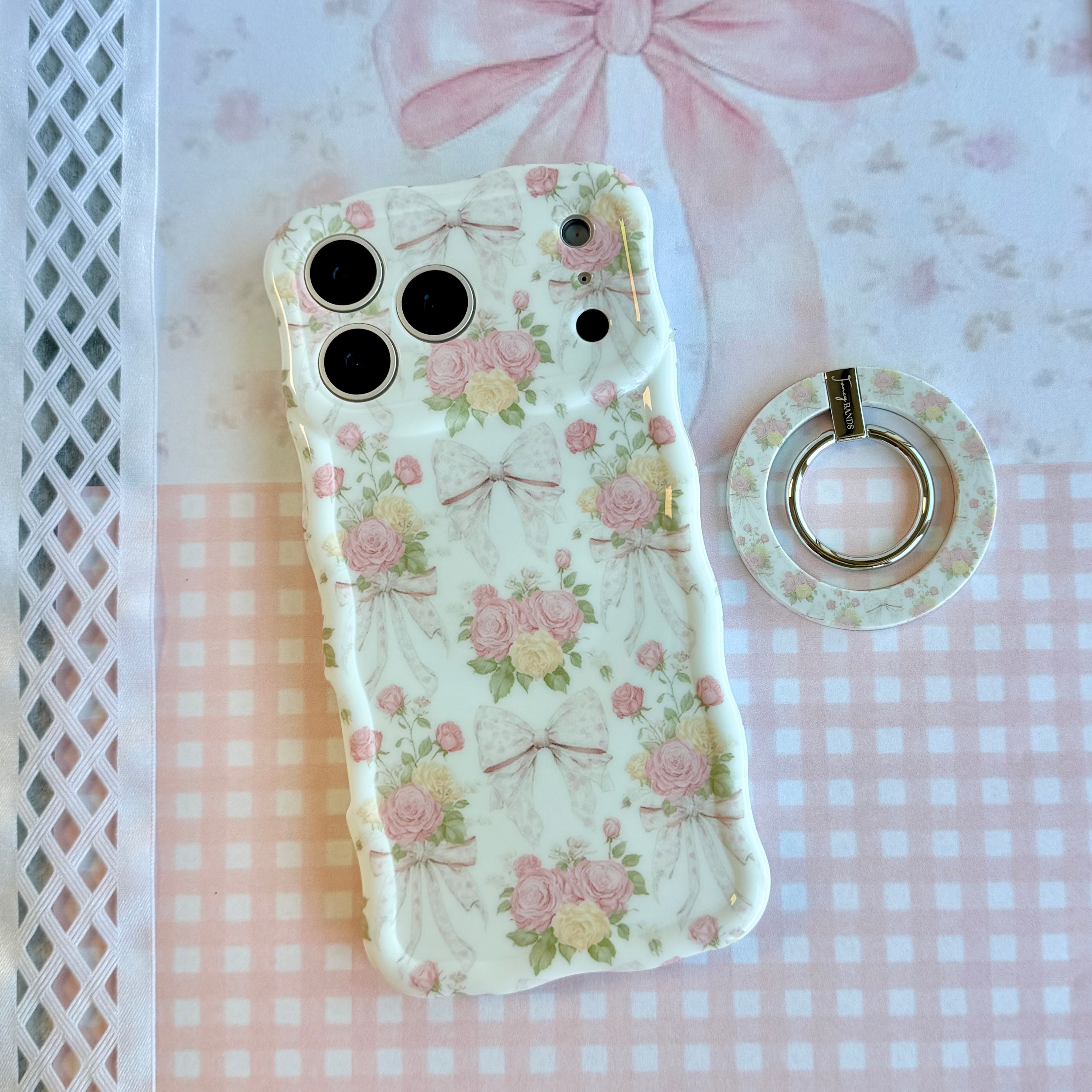 Ribbons and Roses coquette pattern MagSafe phone grip ring with pink roses and white bows on a white background compatible with iPhone and Samsung