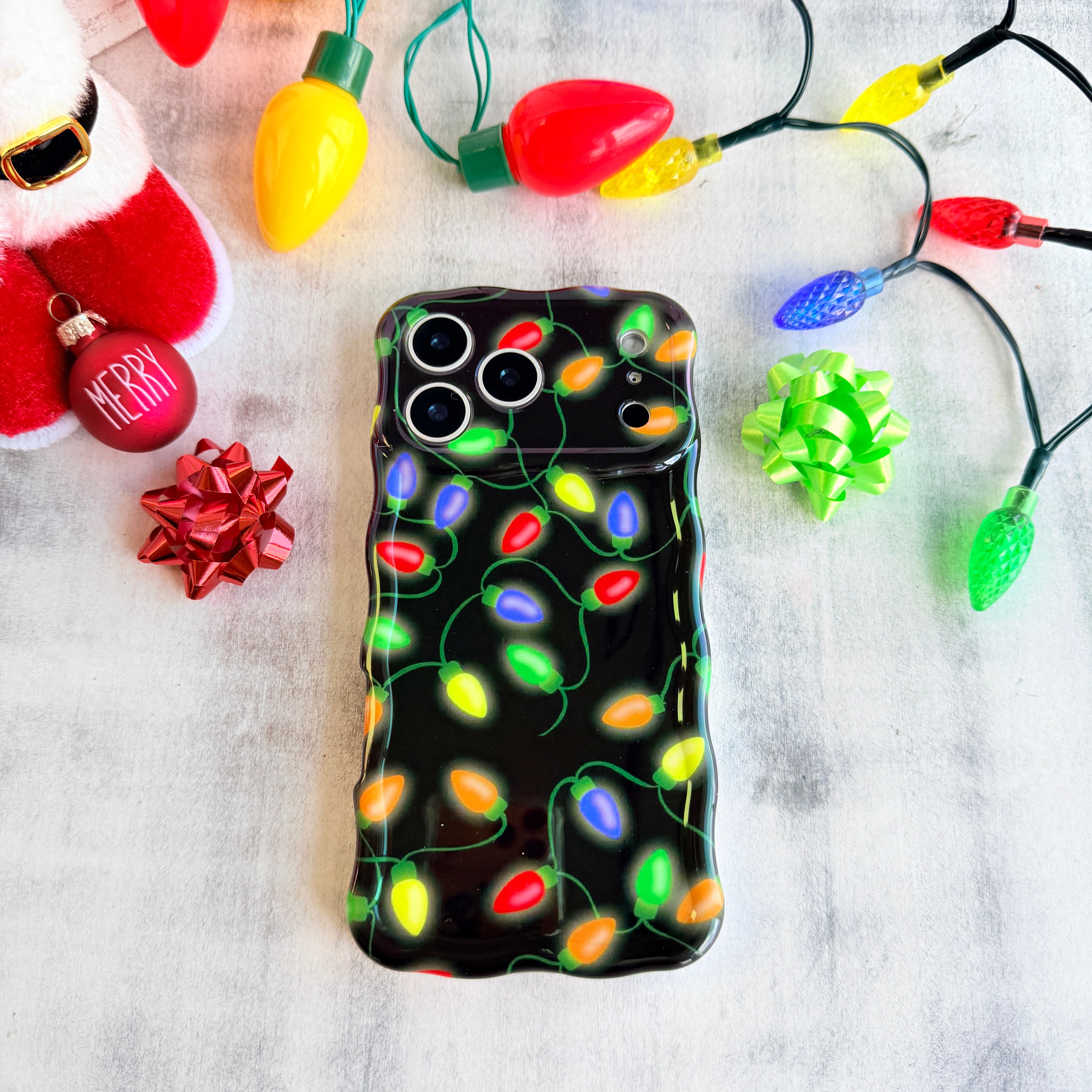 Slim Christmas iPhone case with wavy edges and colorful lights pattern