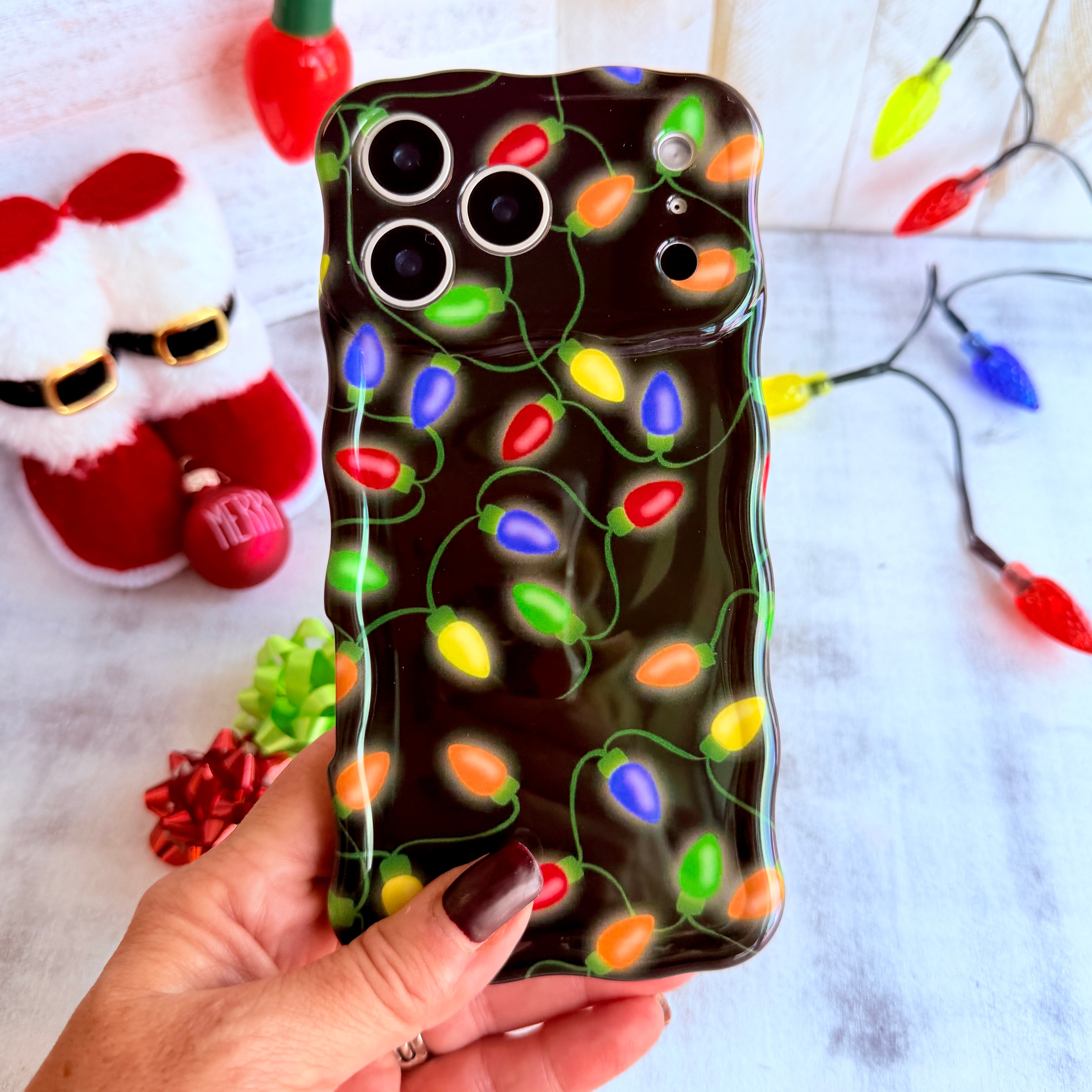 Christmas Lights Wavy Luxe MagSafe iPhone case — glowing multi-color string lights on black
