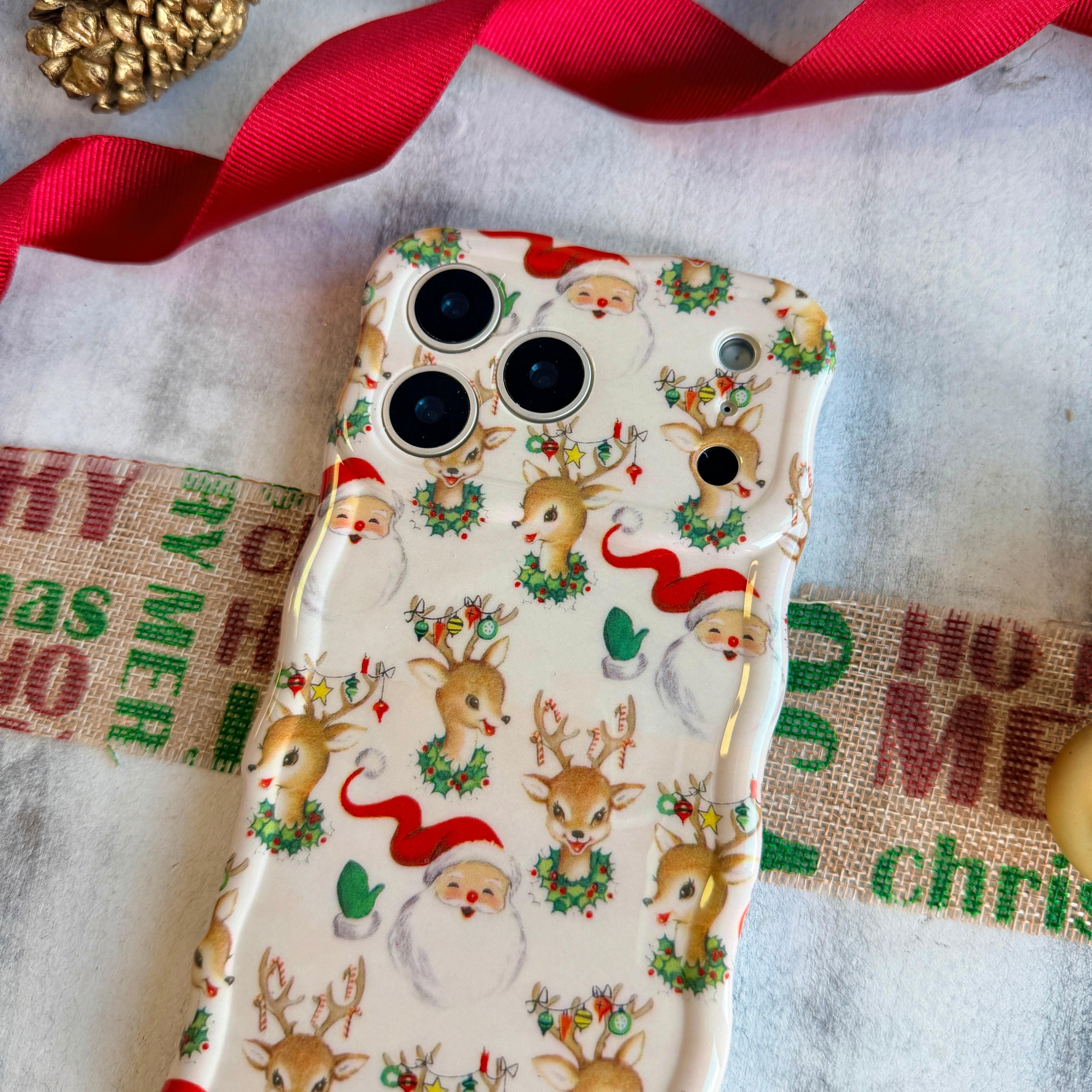 Glossy cream Christmas iPhone case with vintage Santa faces and holly wreaths