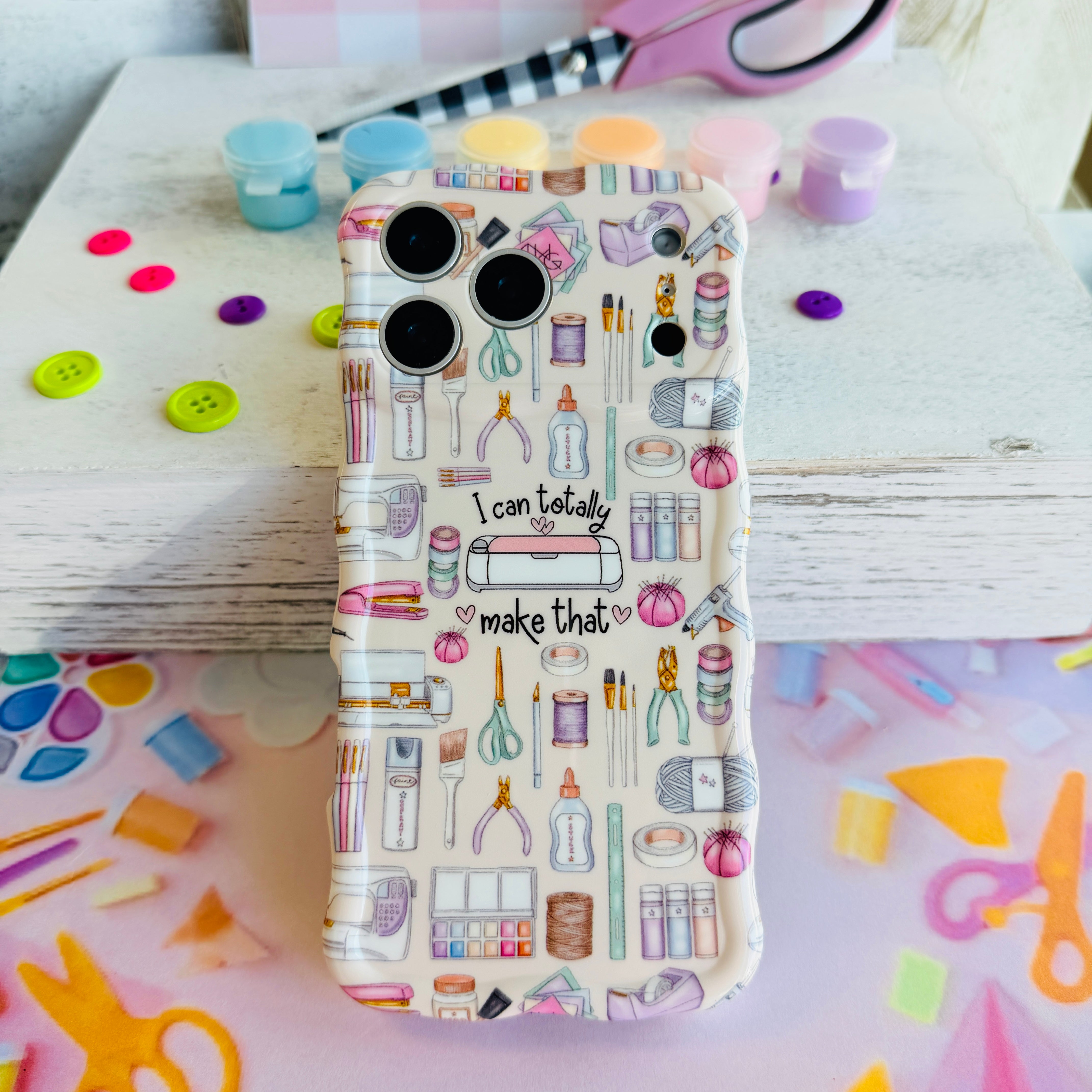 Phone case with stationery-themed design on a colorful background