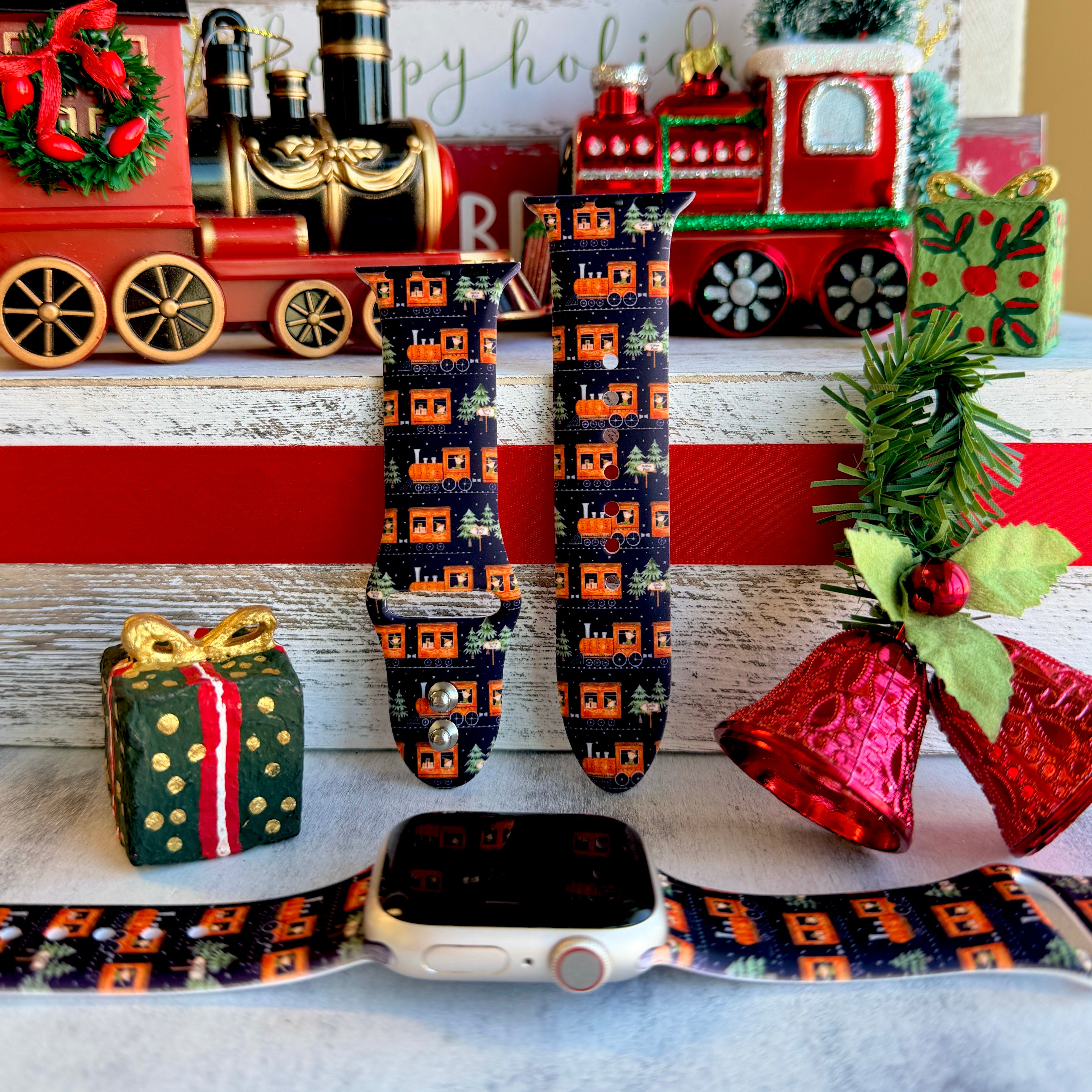 Smartwatch with a festive band on a decorative background with Christmas-themed items.