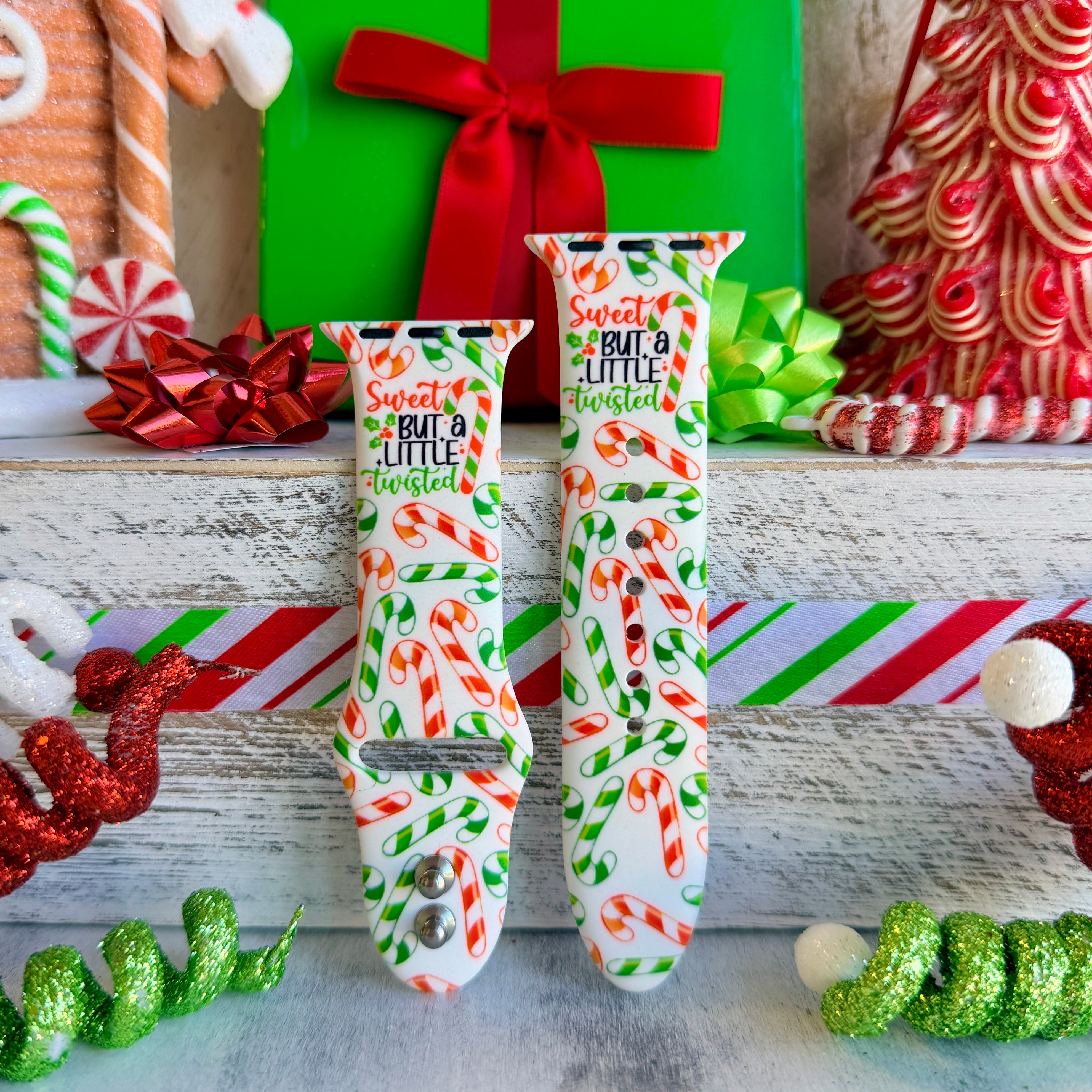 Two Twistmas Vibes Apple Watch bands in different sizes with holiday decorations