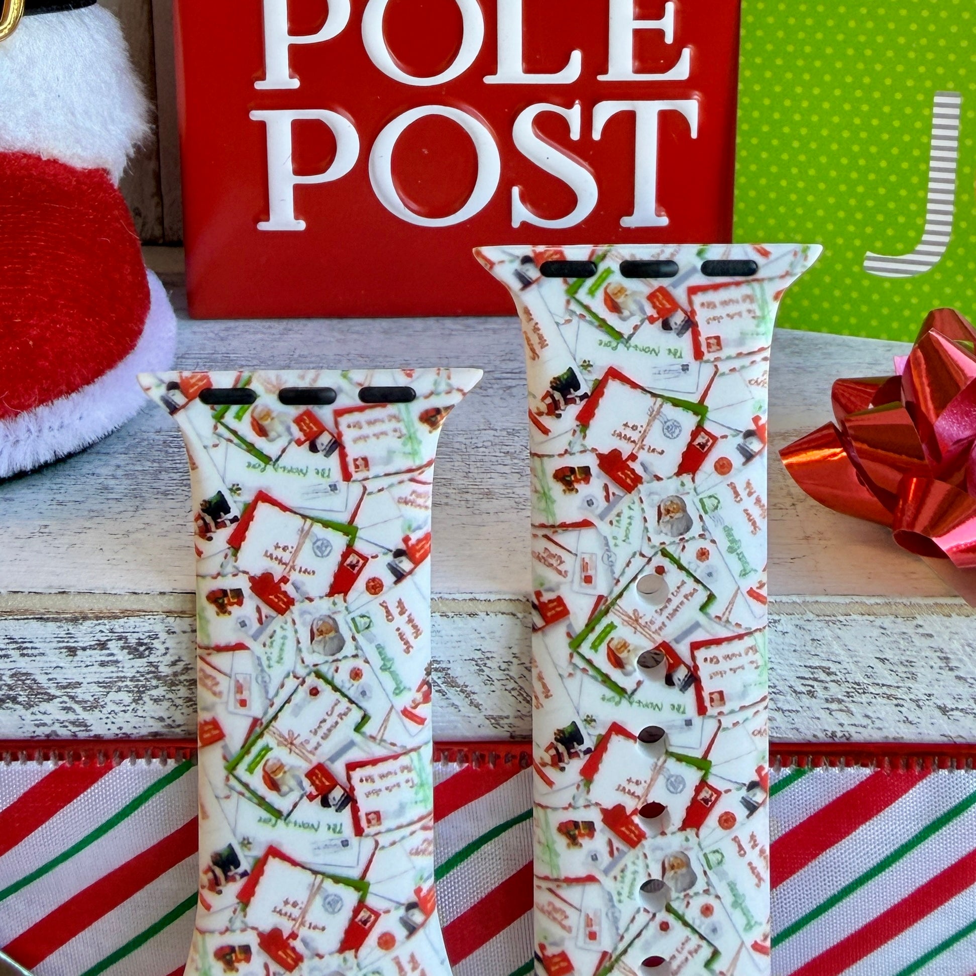 Close-up of Letters to Santa Christmas envelope print pattern on Apple Watch silicone band showing candy canes and stamps