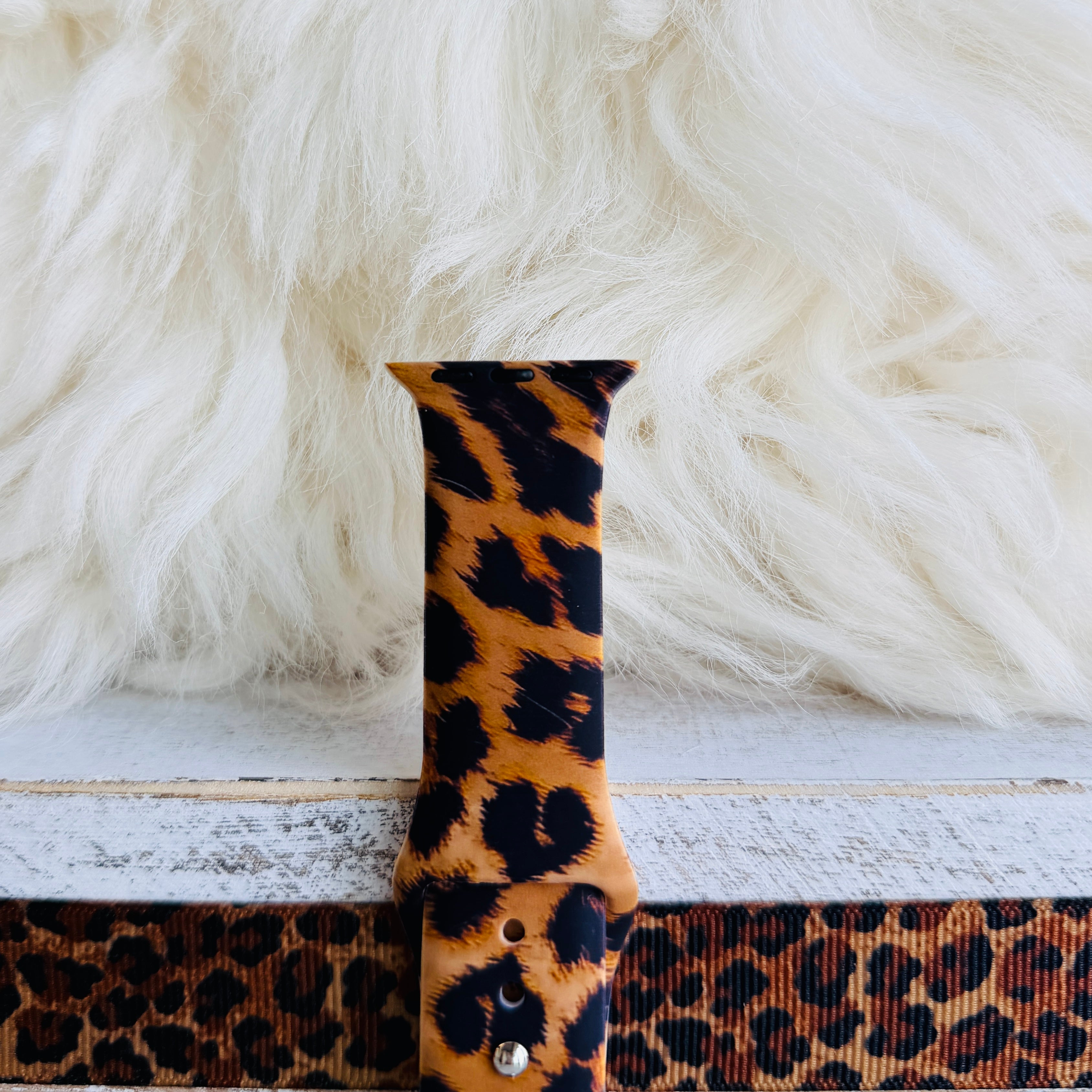 Rawr Mode Apple Watch band with bold tan and black leopard print pattern on white fur background
