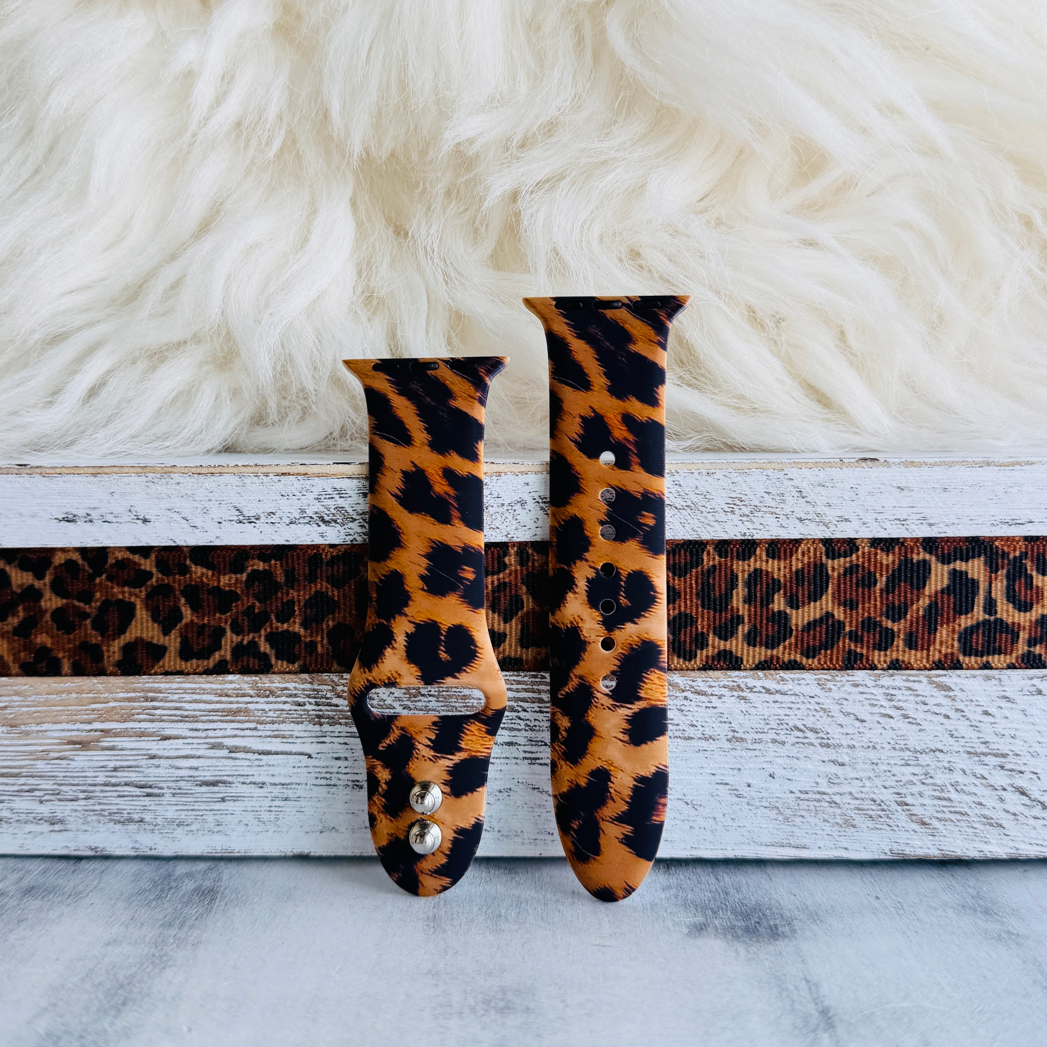 Rawr Mode Apple Watch band with bold tan and black leopard print pattern on white fur background