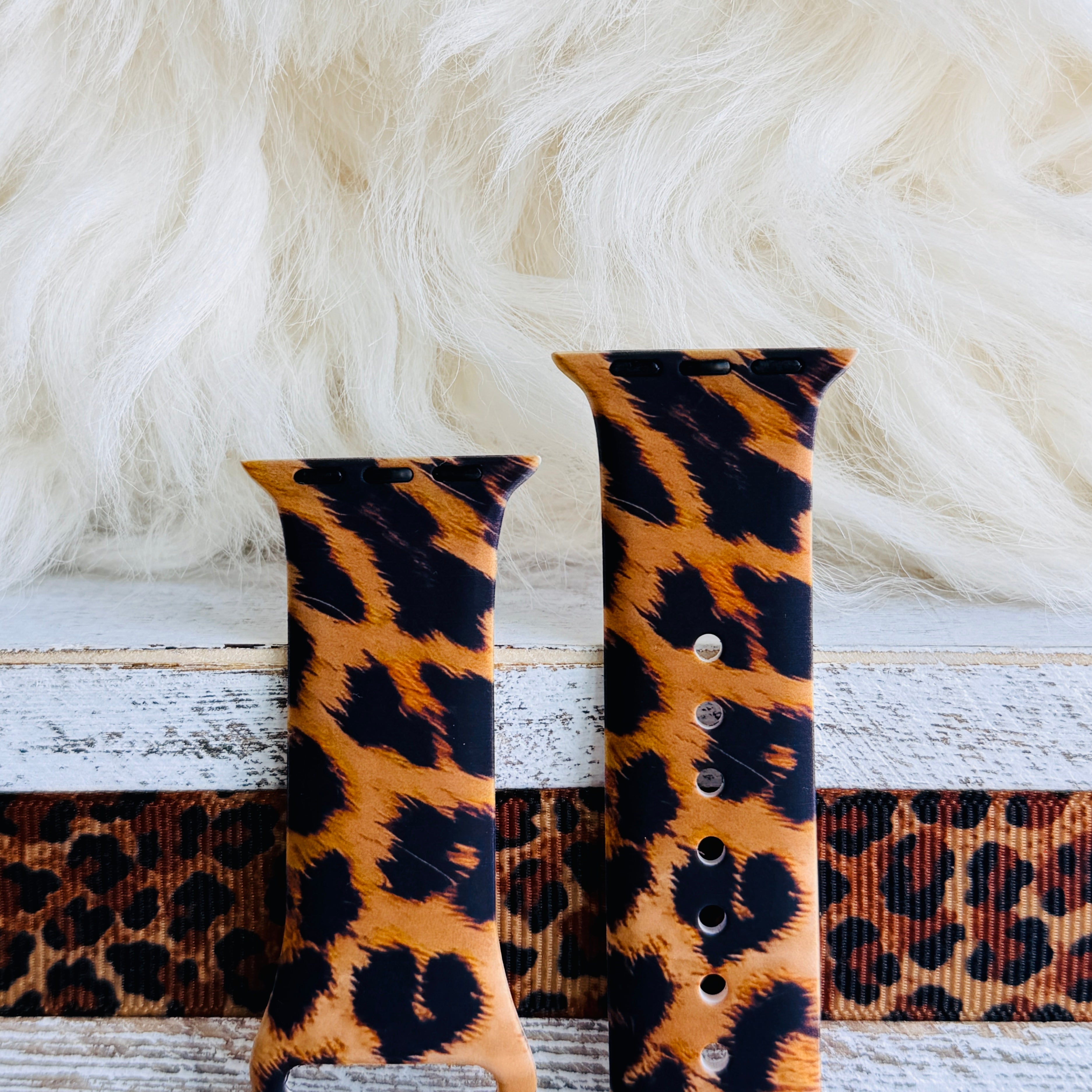 Rawr Mode Apple Watch band with bold tan and black leopard print pattern on white fur background