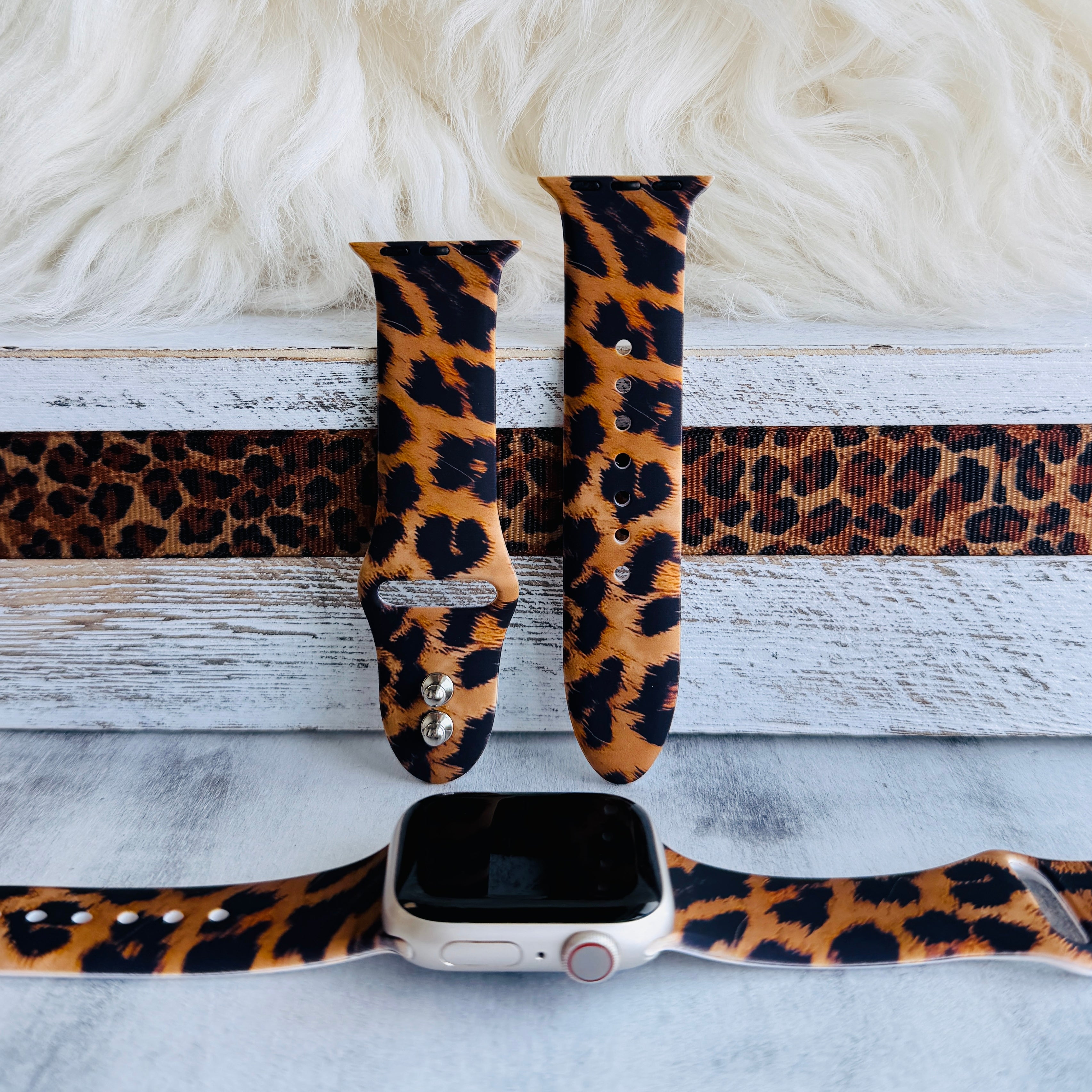 Rawr Mode Apple Watch band with bold tan and black leopard print pattern on white fur background