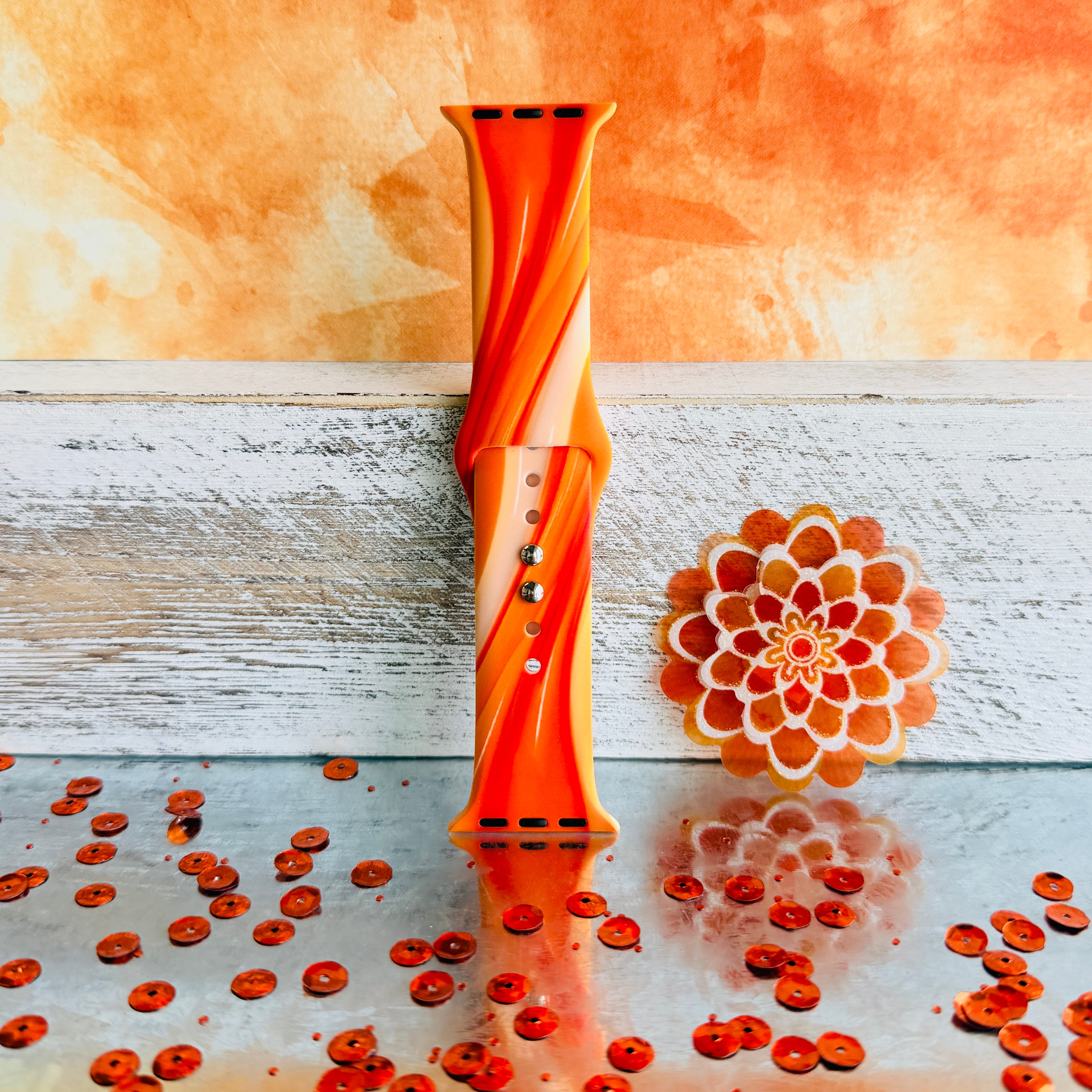 Orange Crush Apple Watch band with vibrant gradient stripes in orange and coral tones with decorative mandala