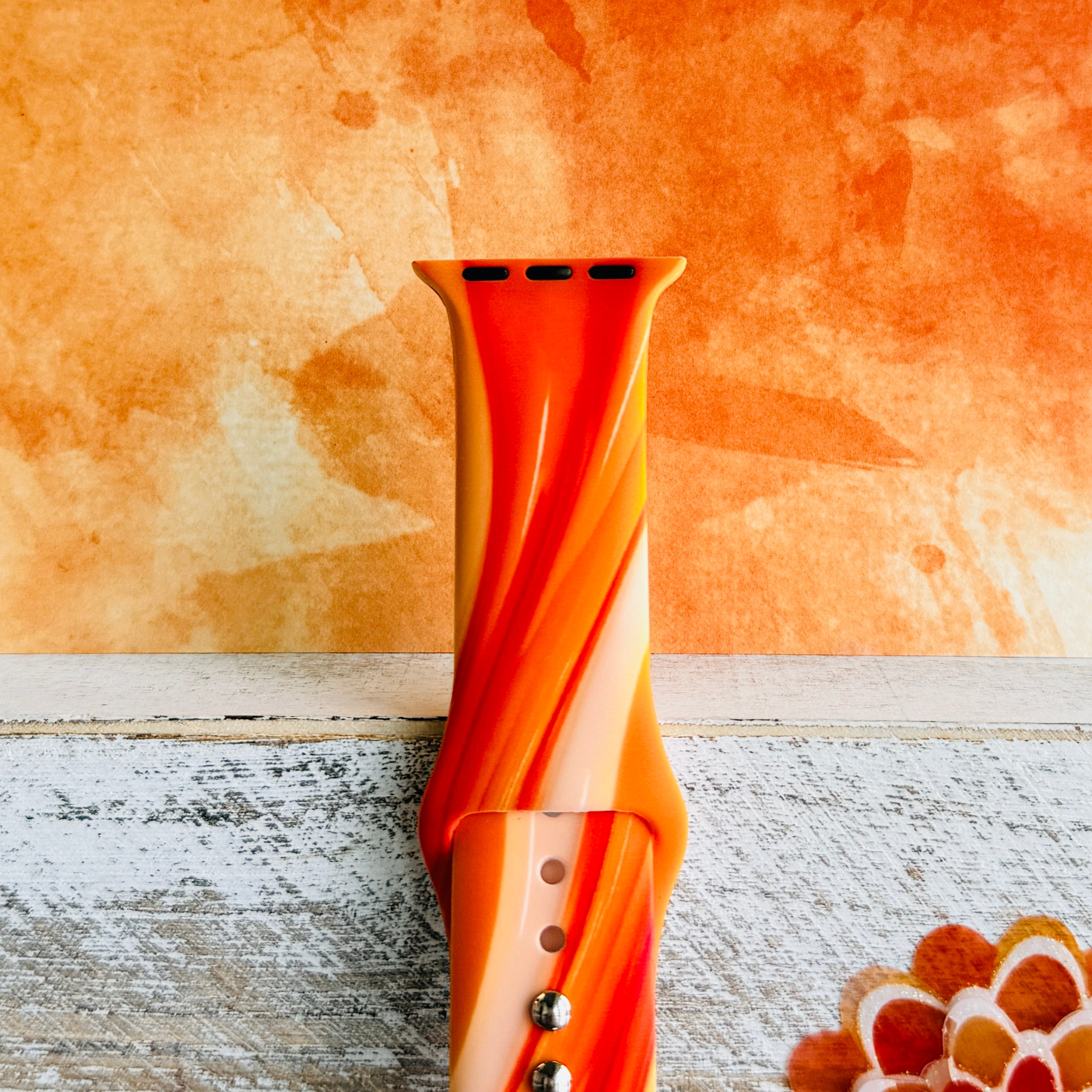 Orange Crush Apple Watch band with vibrant gradient stripes in orange and coral tones with decorative mandala