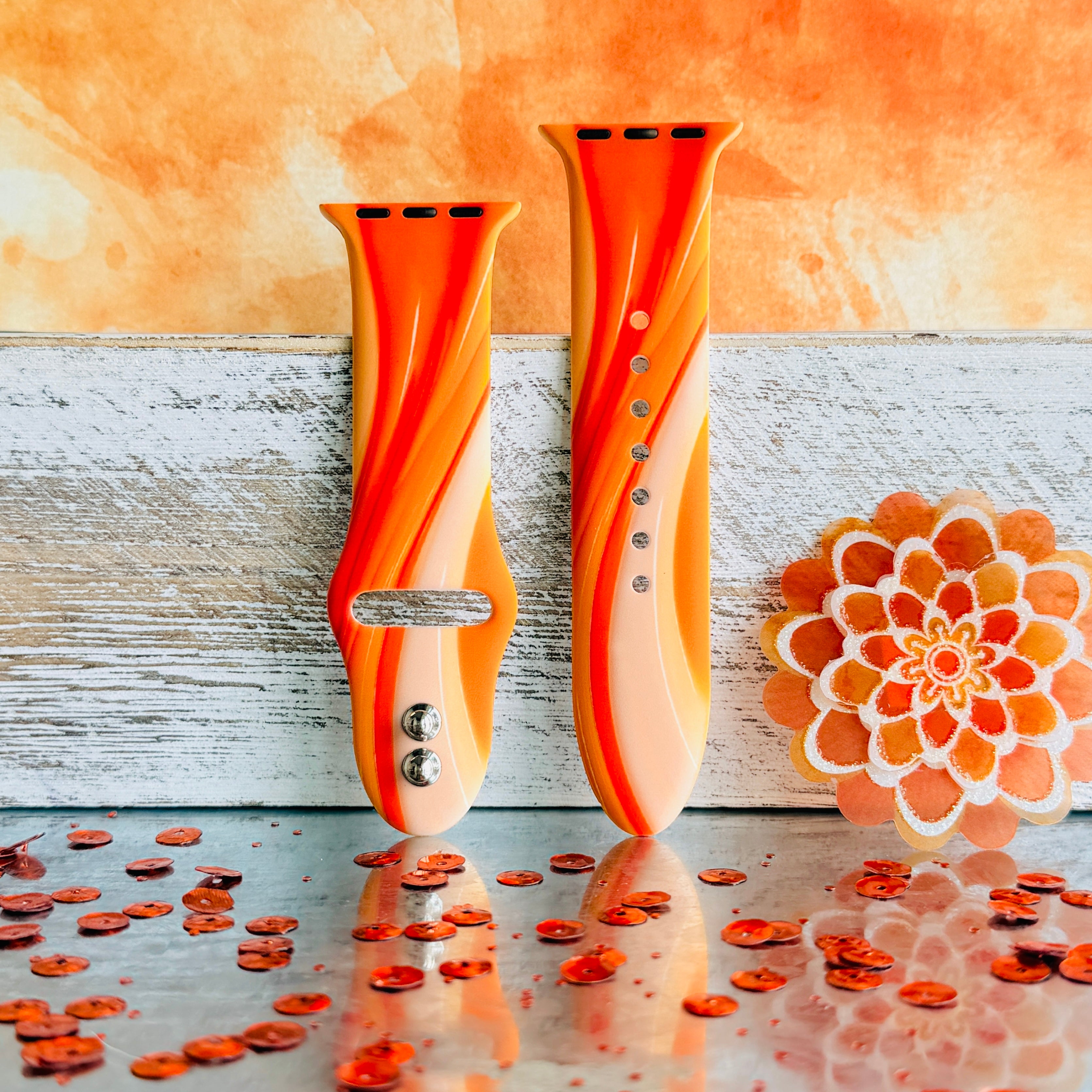 Orange Crush Apple Watch band with vibrant gradient stripes in orange and coral tones with decorative mandala