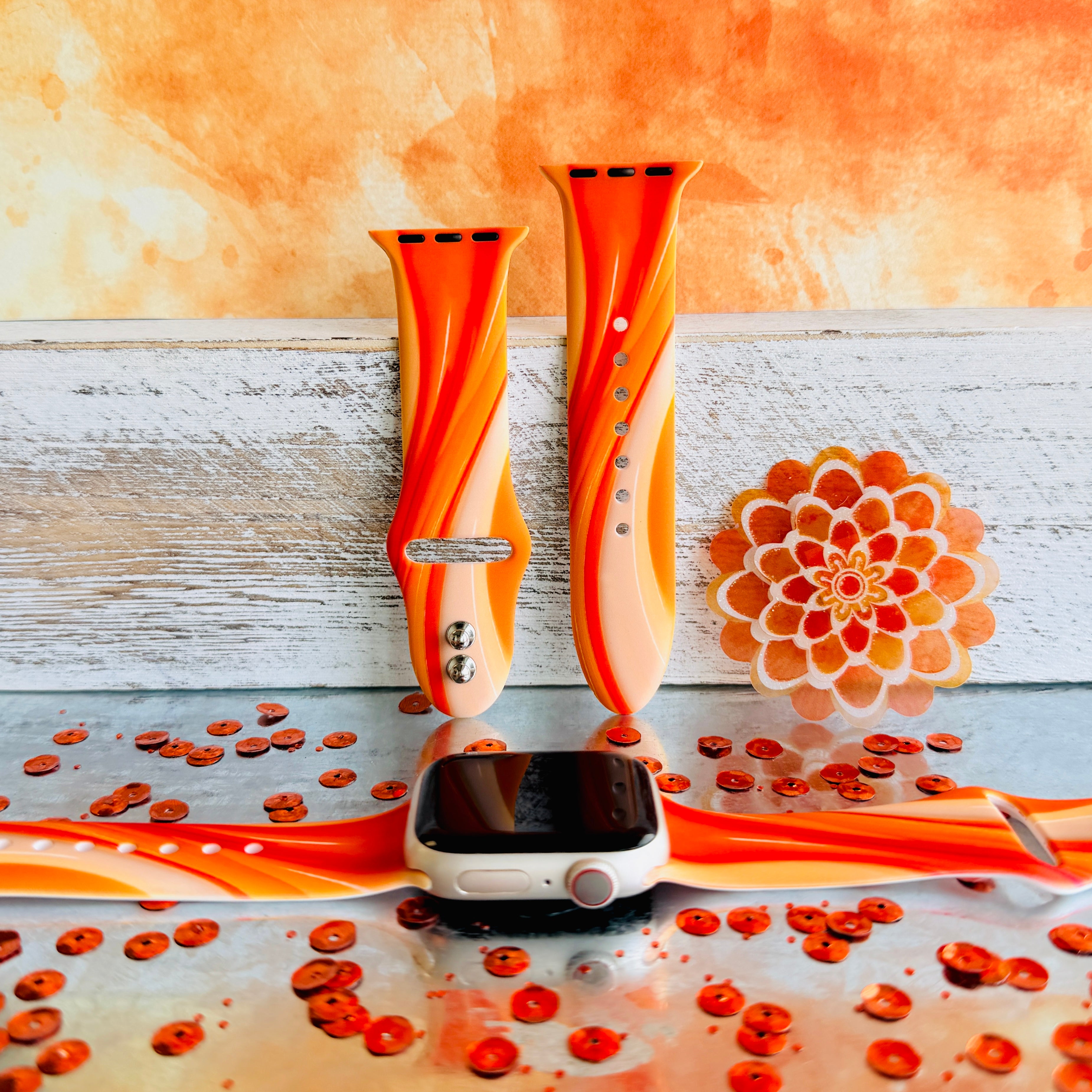 Orange Crush Apple Watch band with vibrant gradient stripes in orange and coral tones with decorative mandala