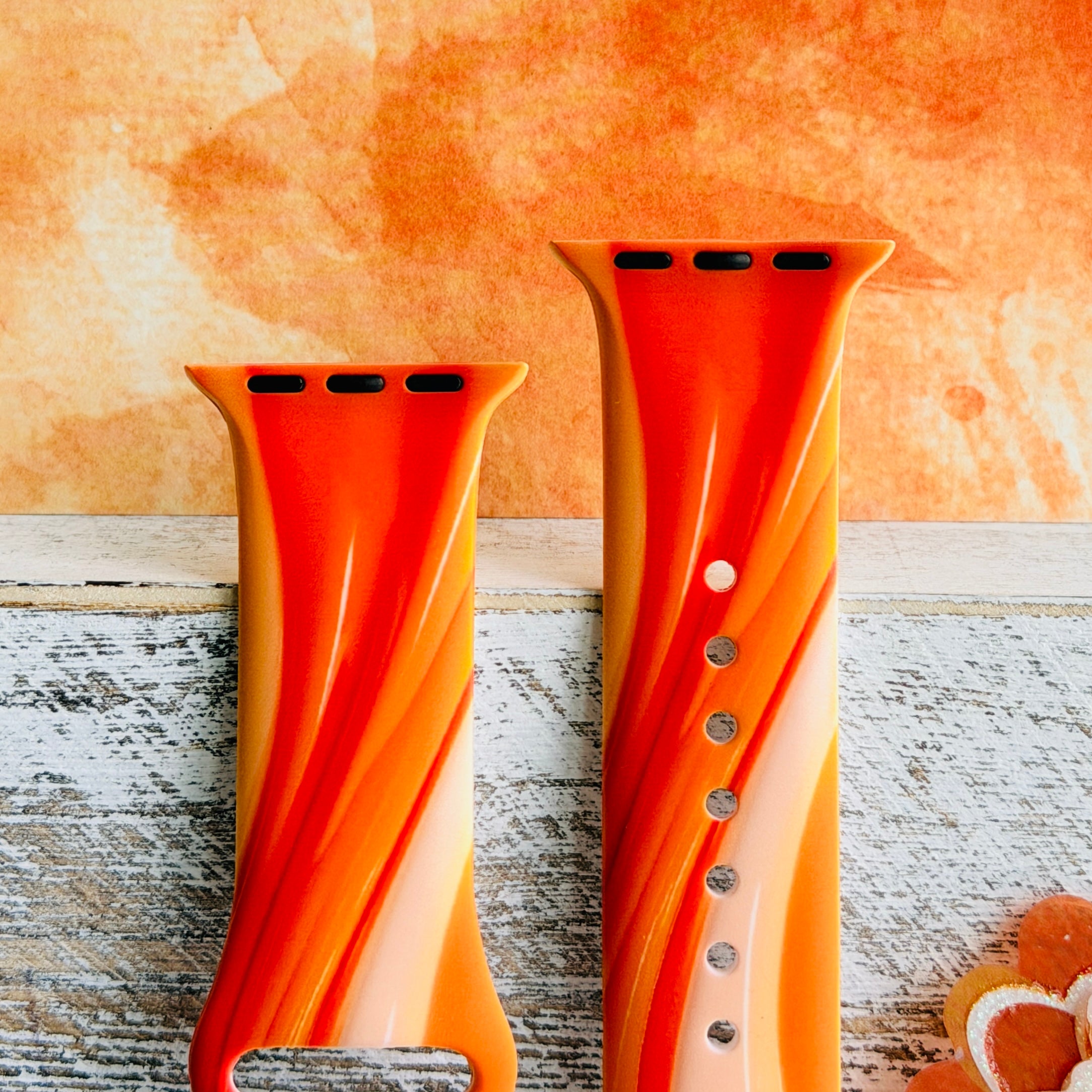 Orange Crush Apple Watch band with vibrant gradient stripes in orange and coral tones with decorative mandala