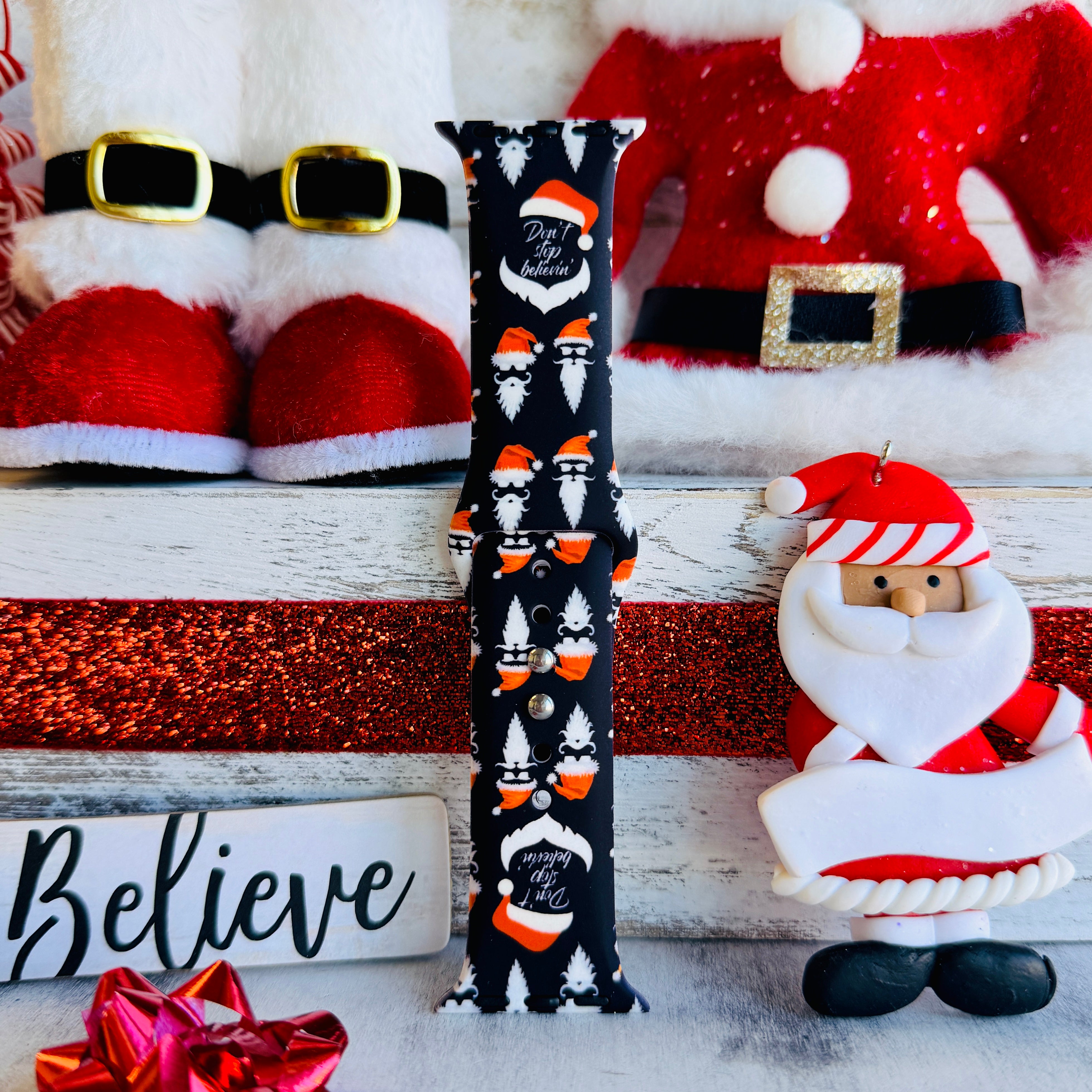 Don't Stop Believin' Apple Watch band styled with Santa Claus decorations and Christmas props