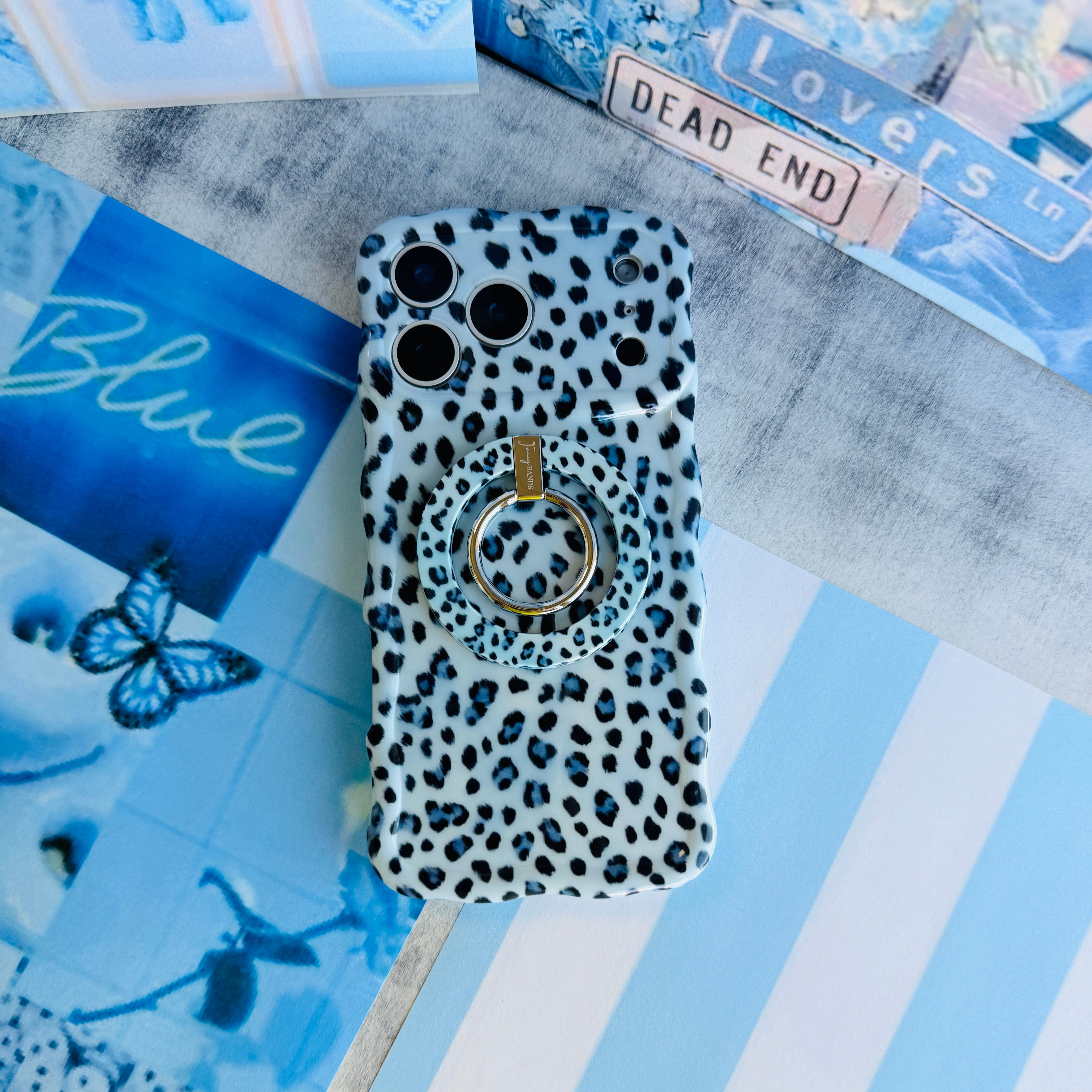 Blue Ice Leopard pattern MagSafe phone grip ring with black and teal leopard spots on a light blue background compatible with iPhone and Samsung