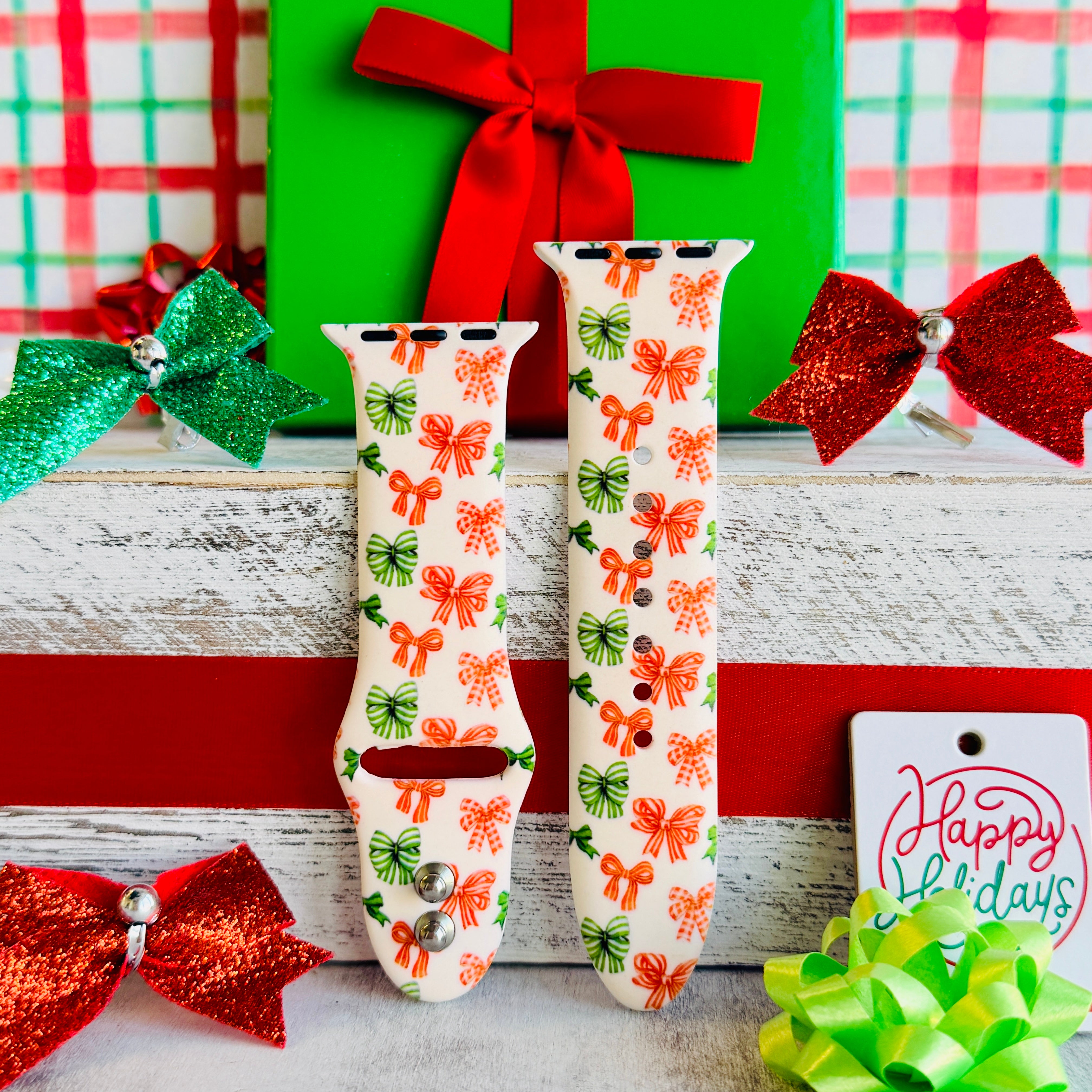 Jingle Bows Apple Watch band styled with wrapped presents, gift bows, and holiday wrapping paper