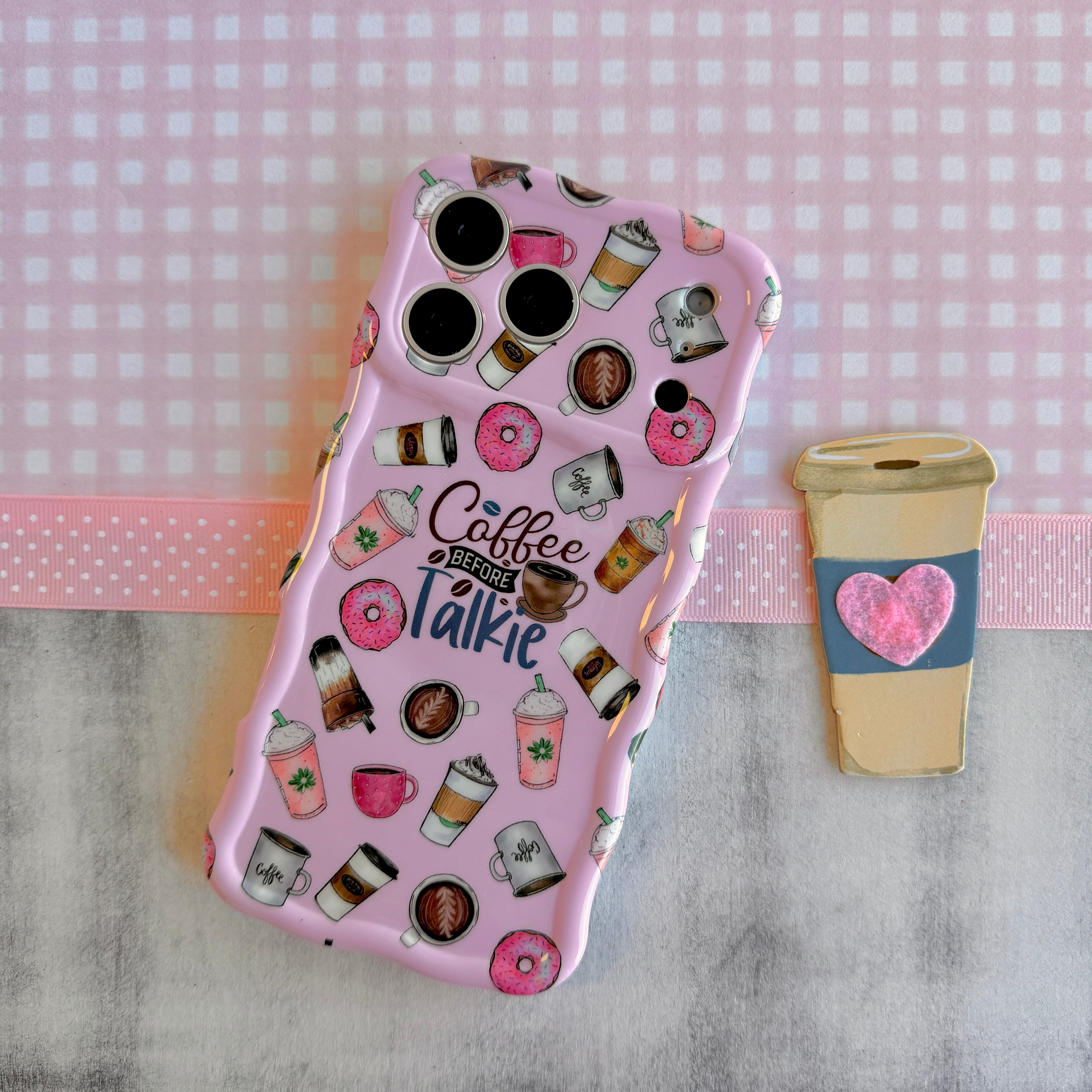 Phone case with coffee-themed design on a checkered background