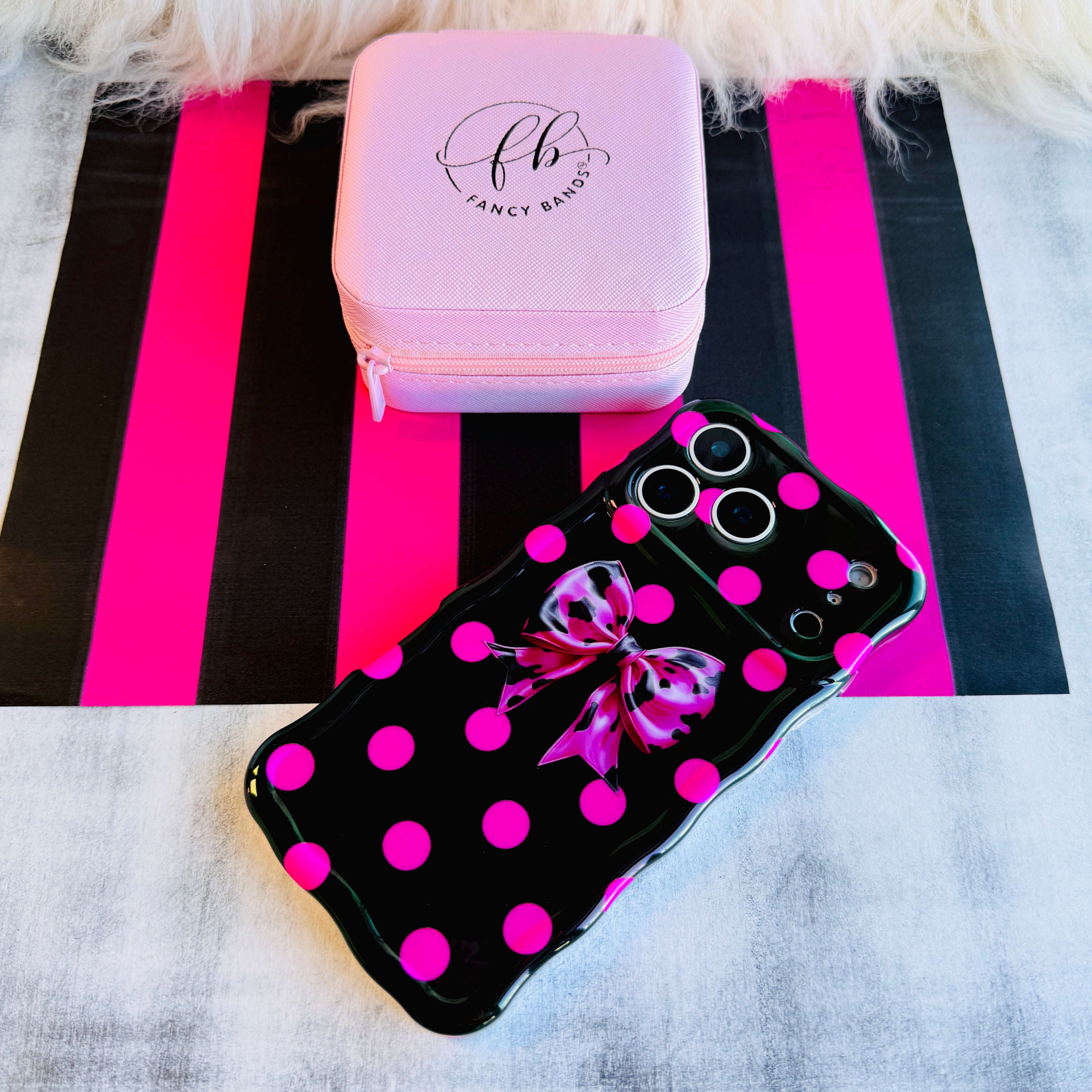 Sweet Spot MagSafe iPhone case with hot pink polka dots and cowhide bow on black by Fancy Bands